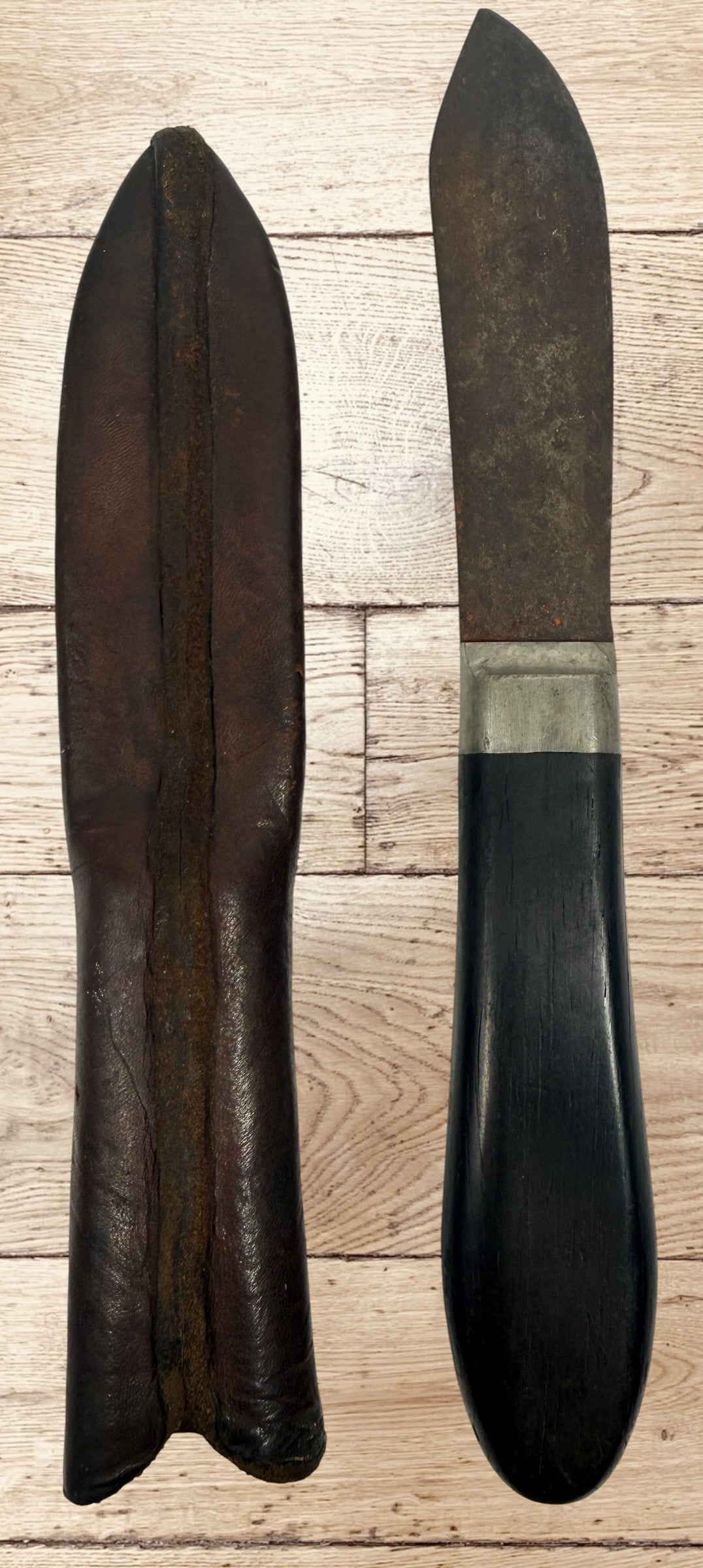 Antique buffalo skinner utility knife with carbon steel blade, hardwood handle, white-metal bolster, and original leather sheath. Classic hunting collectible.