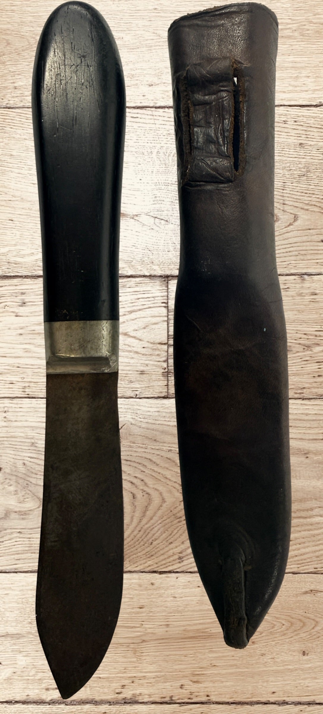 Antique buffalo skinner utility knife with carbon steel blade, hardwood handle, white-metal bolster, and original leather sheath. Classic hunting collectible.