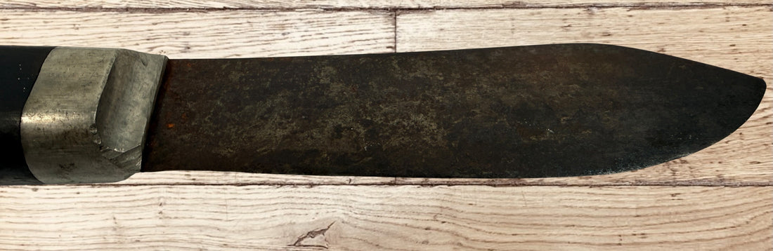 Antique buffalo skinner utility knife with carbon steel blade, hardwood handle, white-metal bolster, and original leather sheath. Classic hunting collectible.