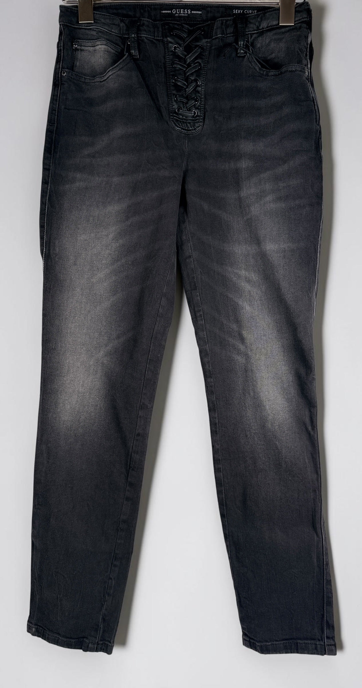 NWT GUESS Sexy Curve Skinny Mid jeans in black vintage wash featuring a lace-up front, stretch denim construction, and flattering curve fit. Size 29x27.
