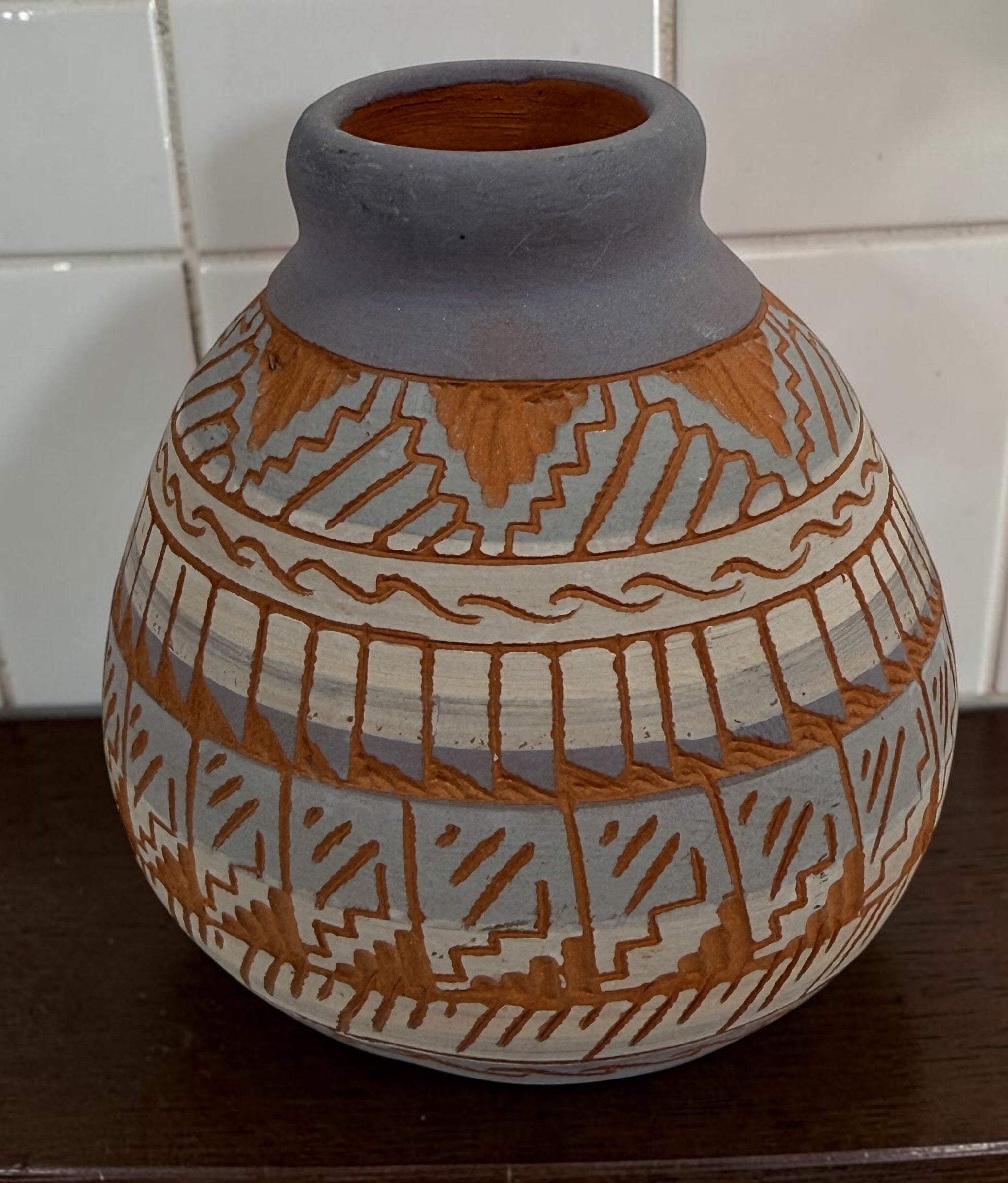 Signed S. Benaly Shiprock NM pottery vase featuring hand-carved Southwest geometric decoration. Vintage studio pottery from New Mexico.