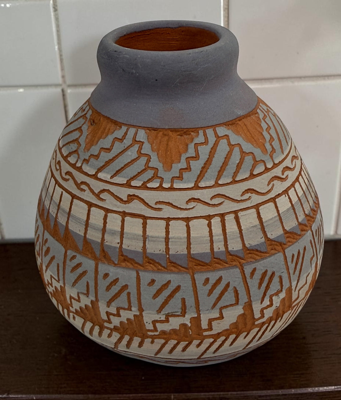 Signed S. Benaly Shiprock NM pottery vase featuring hand-carved Southwest geometric decoration. Vintage studio pottery from New Mexico.