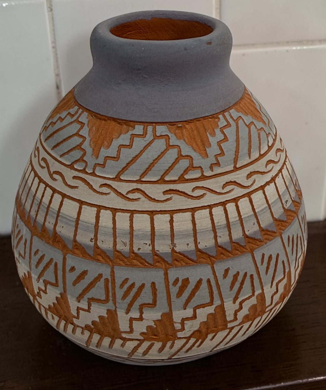 Signed S. Benaly Shiprock NM pottery vase featuring hand-carved Southwest geometric decoration. Vintage studio pottery from New Mexico.