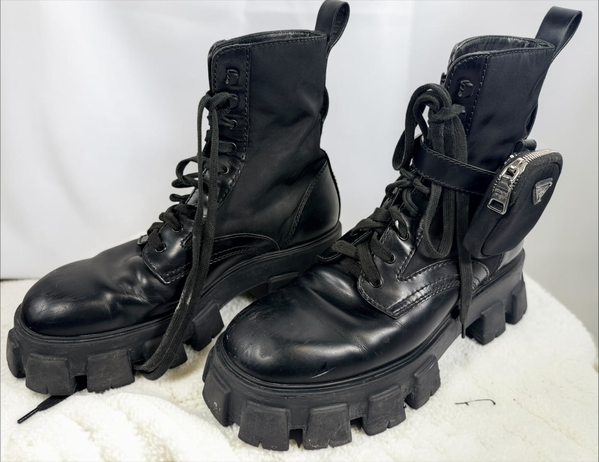 Black Monolith style combat boots with oversized lug soles and one detachable utility pouch. Size 39.5. Bold designer-inspired fashion footwear.