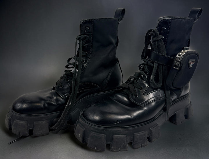 Black Monolith style combat boots with oversized lug soles and one detachable utility pouch. Size 39.5. Bold designer-inspired fashion footwear.