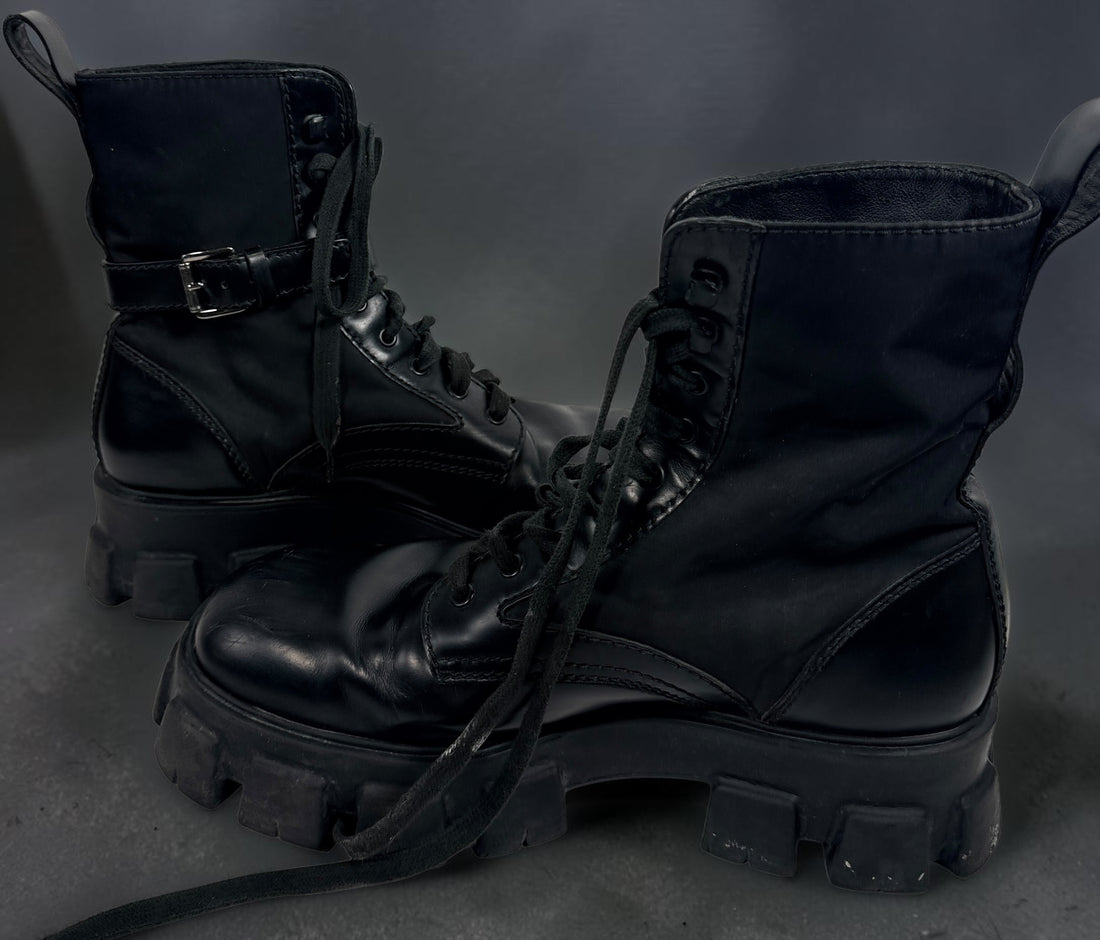 Black Monolith style combat boots with oversized lug soles and one detachable utility pouch. Size 39.5. Bold designer-inspired fashion footwear.
