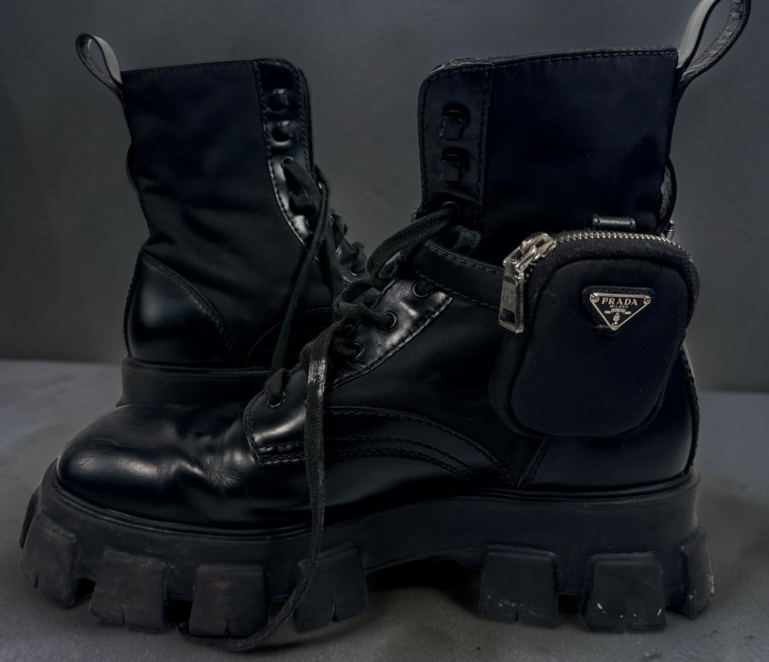 Black Monolith style combat boots with oversized lug soles and one detachable utility pouch. Size 39.5. Bold designer-inspired fashion footwear.