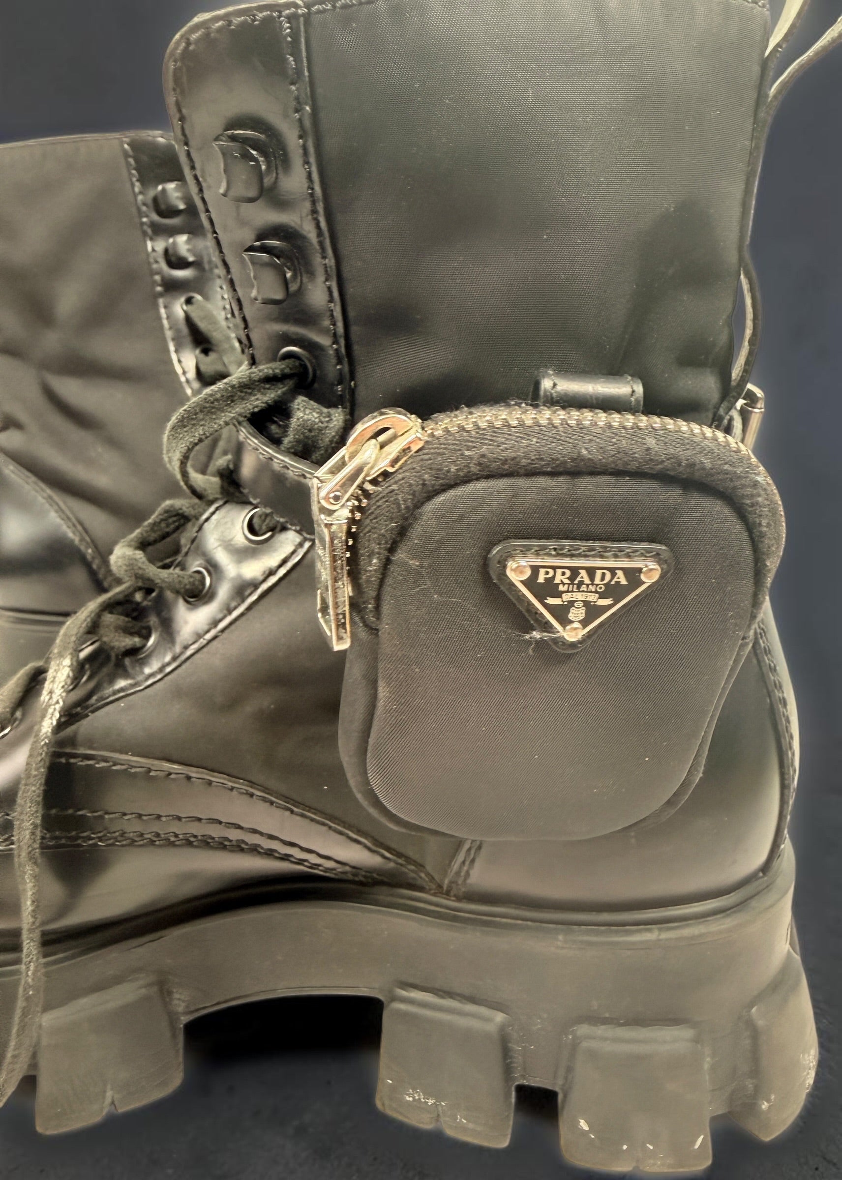 Black Monolith style combat boots with oversized lug soles and one detachable utility pouch. Size 39.5. Bold designer-inspired fashion footwear.