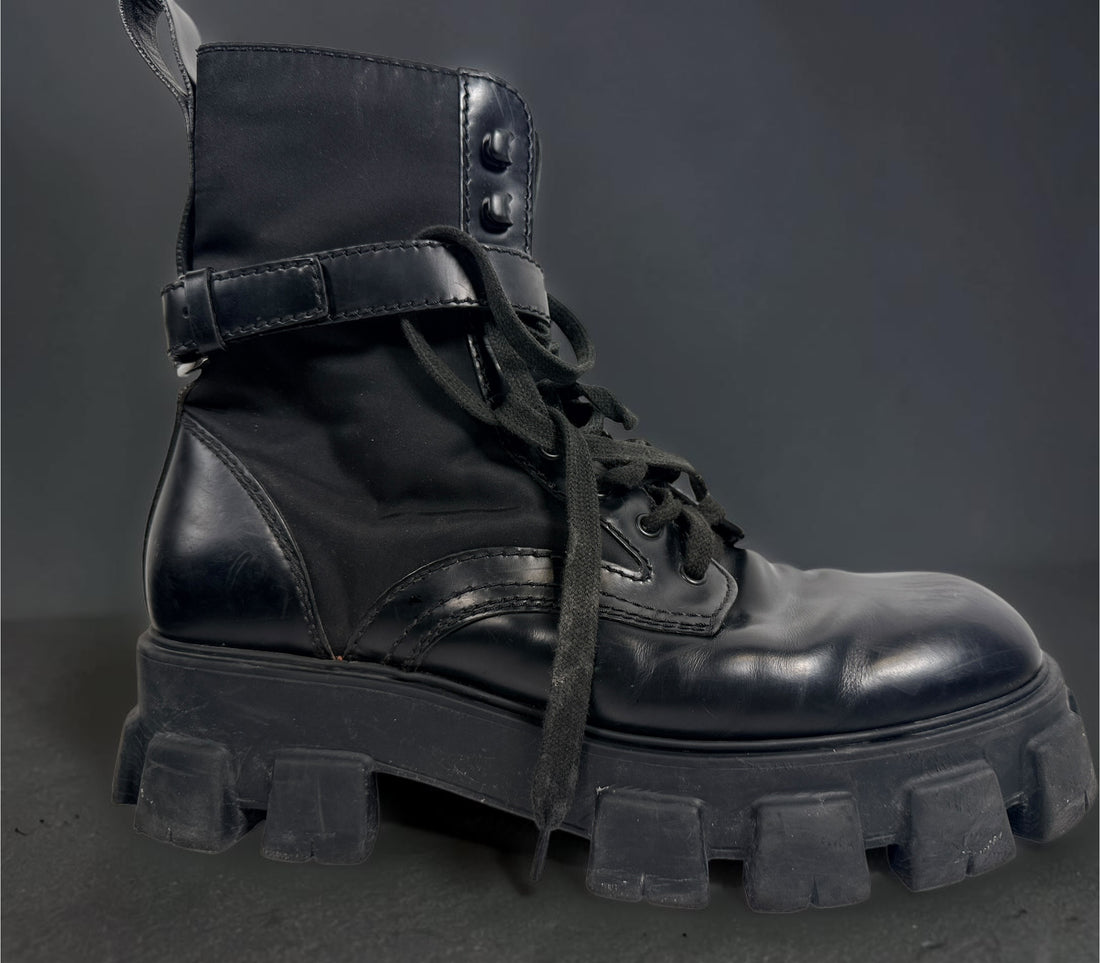 Black Monolith style combat boots with oversized lug soles and one detachable utility pouch. Size 39.5. Bold designer-inspired fashion footwear.