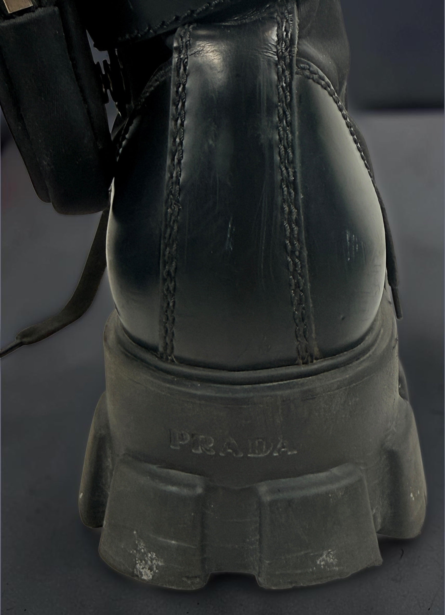 Black Monolith style combat boots with oversized lug soles and one detachable utility pouch. Size 39.5. Bold designer-inspired fashion footwear.