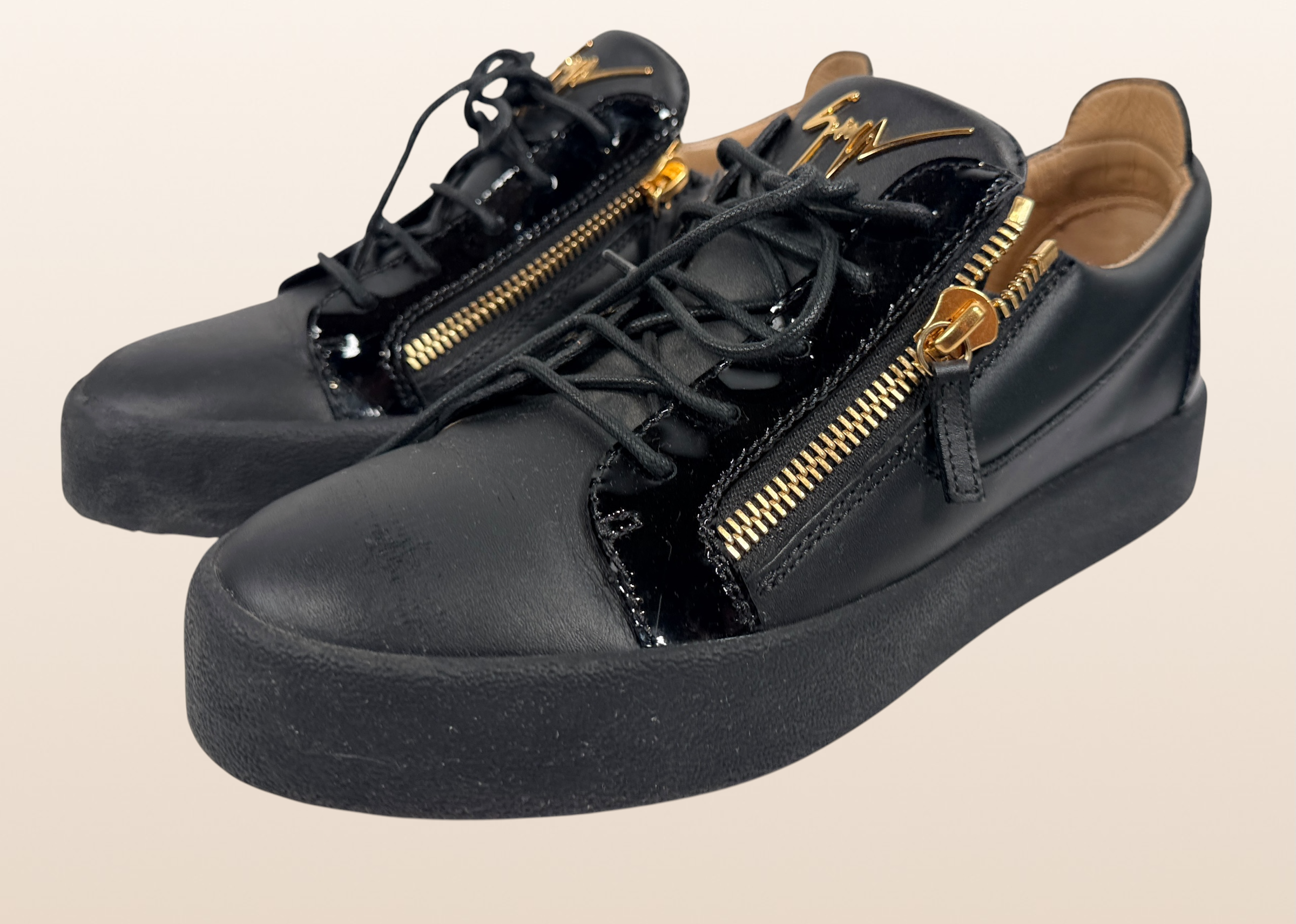 Authentic Giuseppe Zanotti black leather platform sneakers made in Italy featuring gold signature hardware, dual side zippers, leather lining, and rubber platform soles in EU 43.