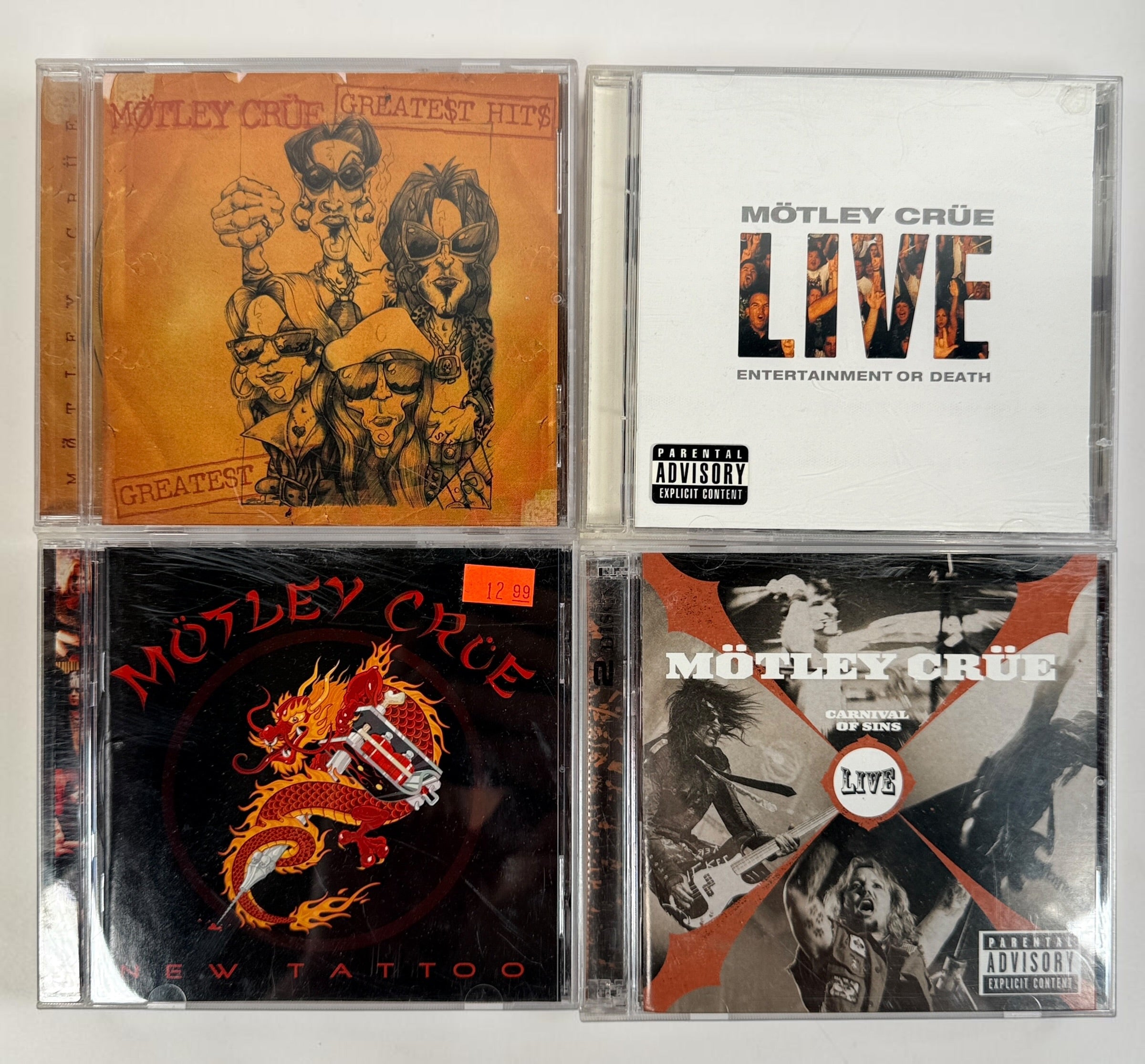 Original Mötley Crüe CD collection including Greatest Hits, Live: Entertainment or Death, Carnival of Sins Live, and New Tattoo with original cases.
