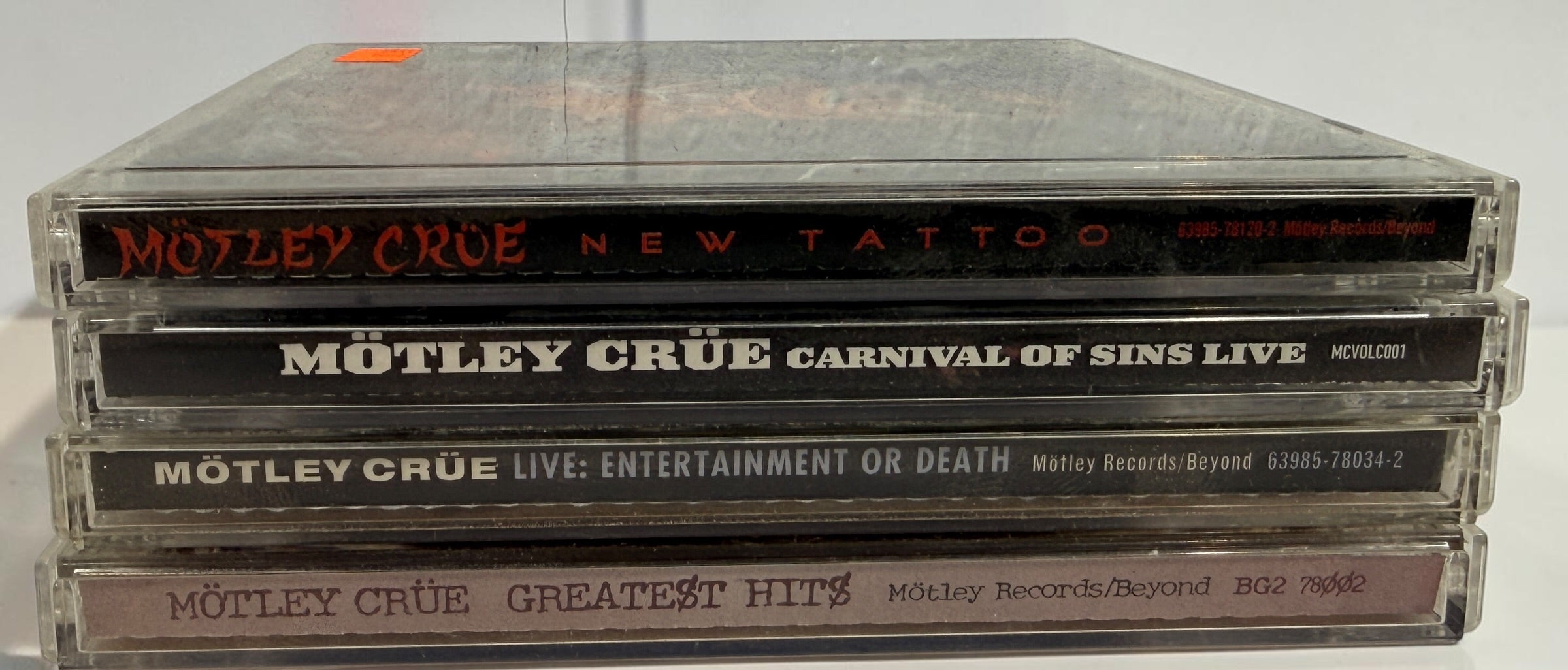 Original Mötley Crüe CD collection including Greatest Hits, Live: Entertainment or Death, Carnival of Sins Live, and New Tattoo with original cases.