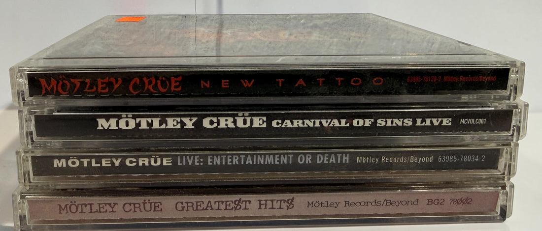 Original Mötley Crüe CD collection including Greatest Hits, Live: Entertainment or Death, Carnival of Sins Live, and New Tattoo with original cases.