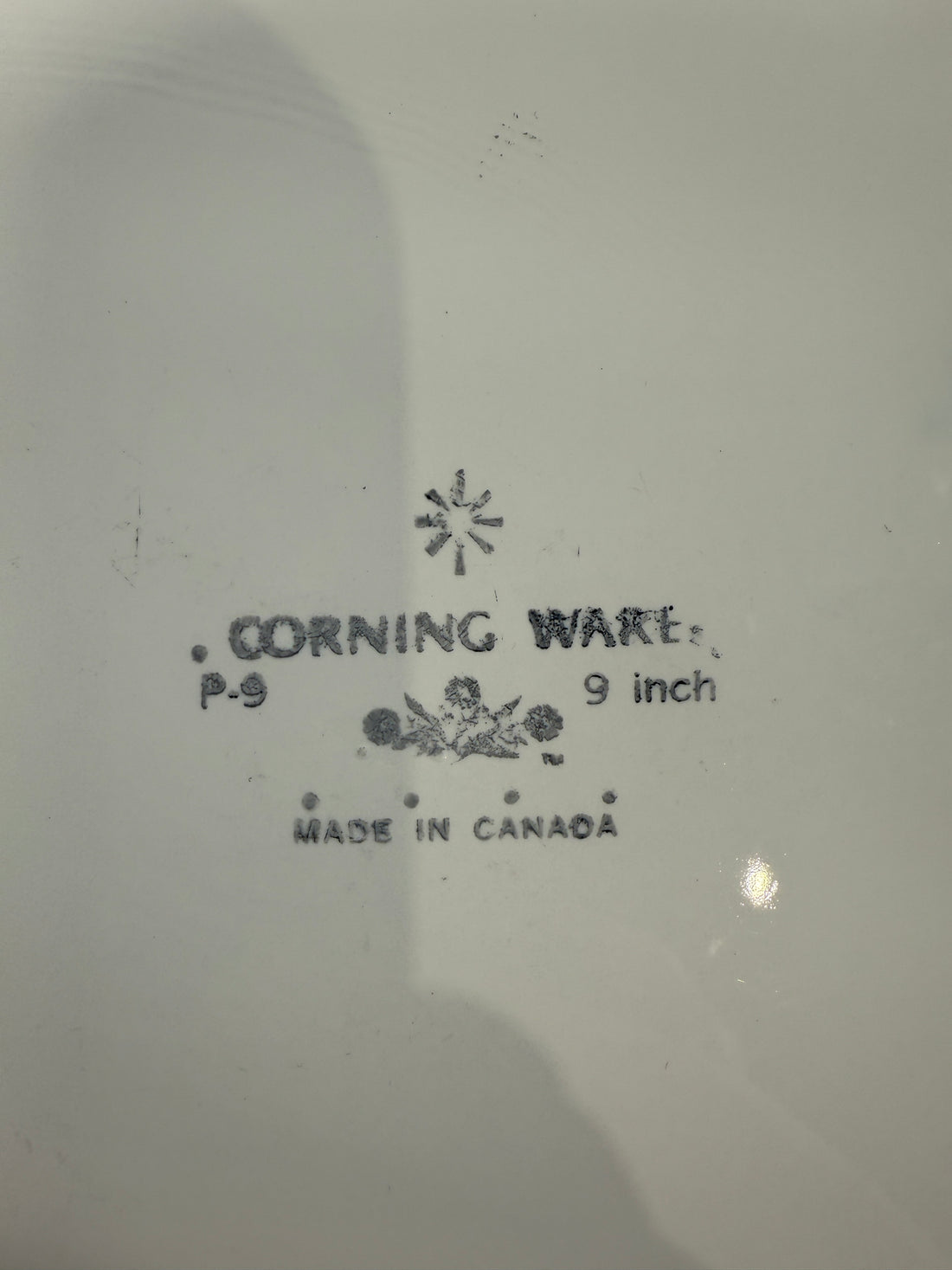 Corning Ware dish with branding and size information on a white background