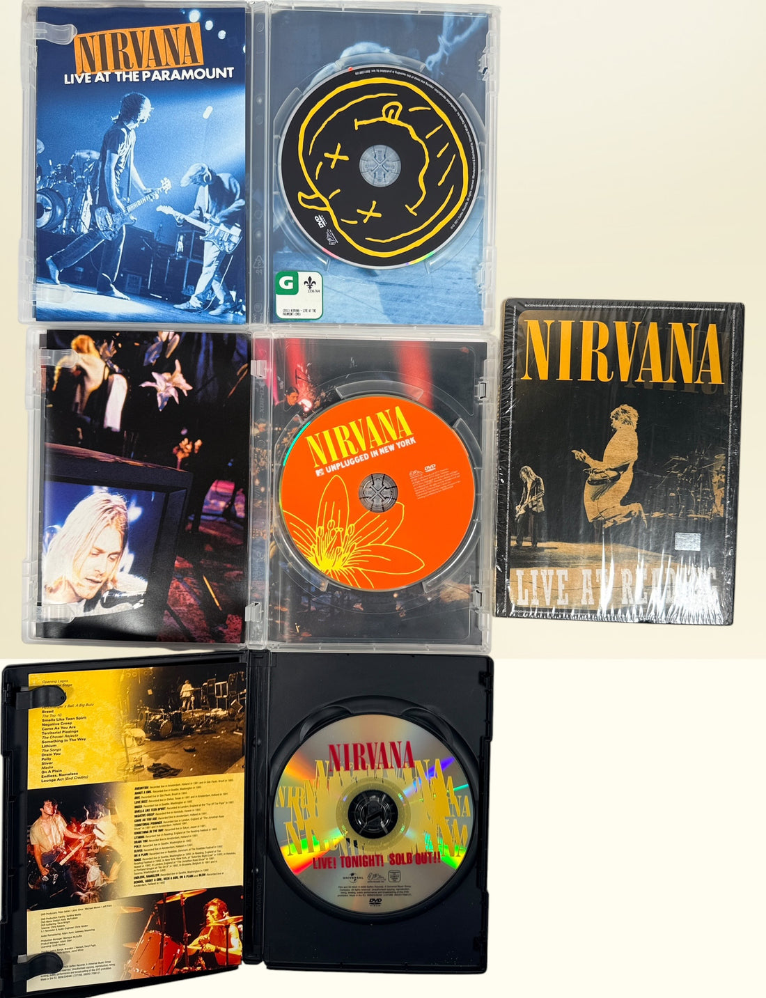 Official Nirvana DVD collection featuring MTV Unplugged, Live at the Paramount, Live! Tonight! Sold Out!!, and factory-sealed Live at Reading.
