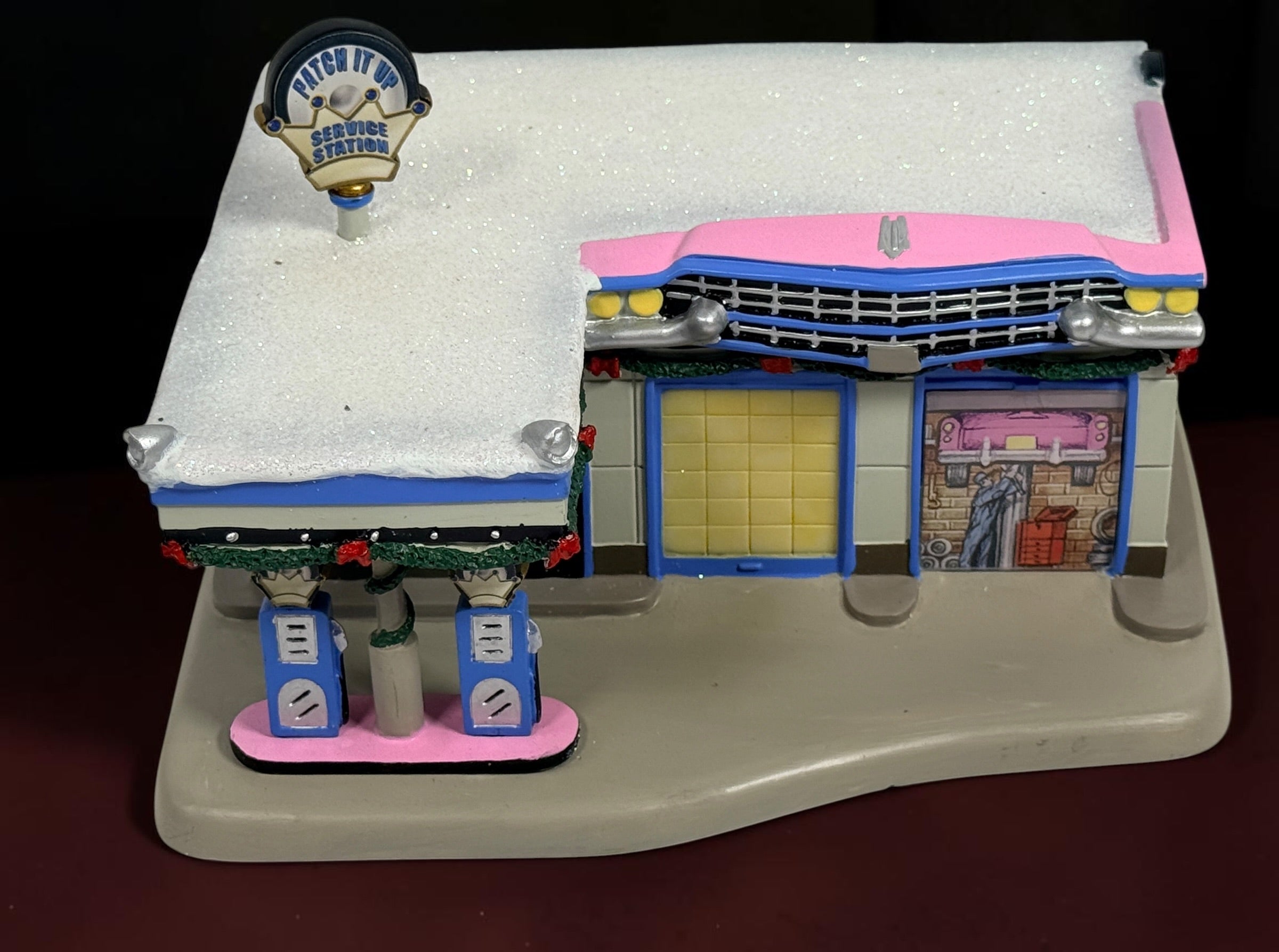 Retired 2009 Hawthorne Village Elvis Presley Patch It Up Service Station from the Rock ‘n’ Roll Holiday Village collection. Light cord not included.