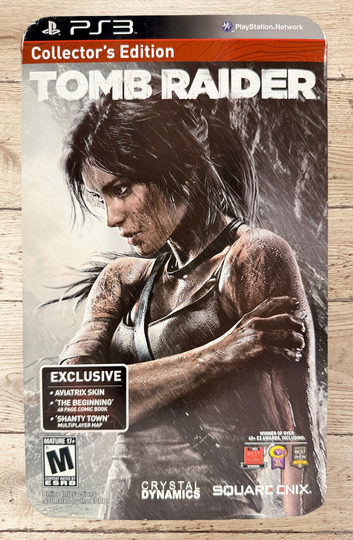 Complete Tomb Raider PS3 Collector’s Edition Survival Kit with Lara Croft figure, soundtrack CD, comic, map, sealed badges, lithograph and original metal collector’s tin.