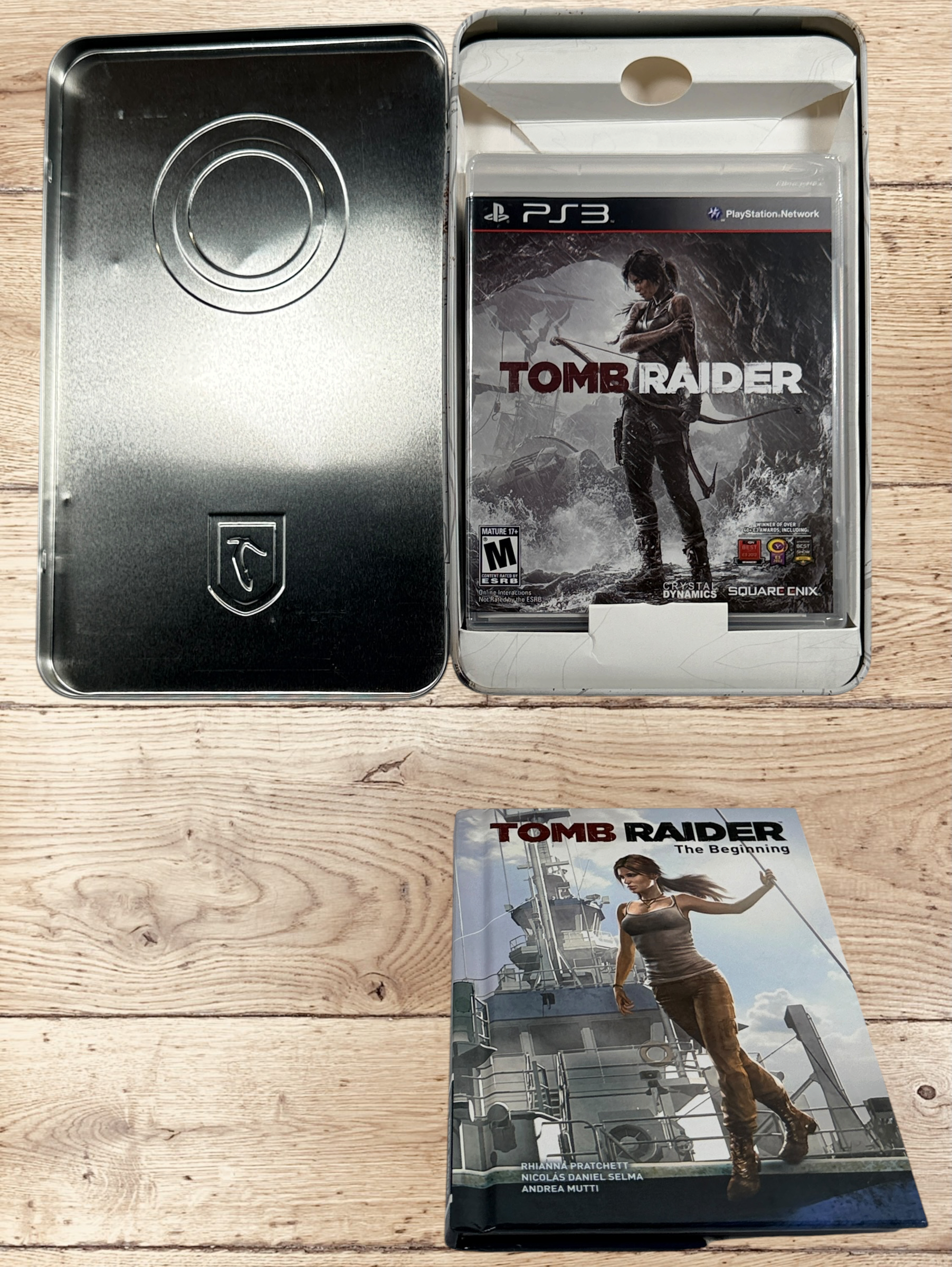 Complete Tomb Raider PS3 Collector’s Edition Survival Kit with Lara Croft figure, soundtrack CD, comic, map, sealed badges, lithograph and original metal collector’s tin.