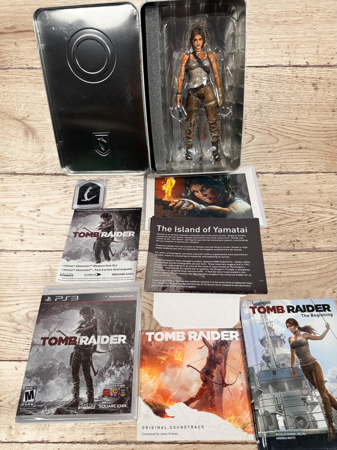 Complete Tomb Raider PS3 Collector’s Edition Survival Kit with Lara Croft figure, soundtrack CD, comic, map, sealed badges, lithograph and original metal collector’s tin.