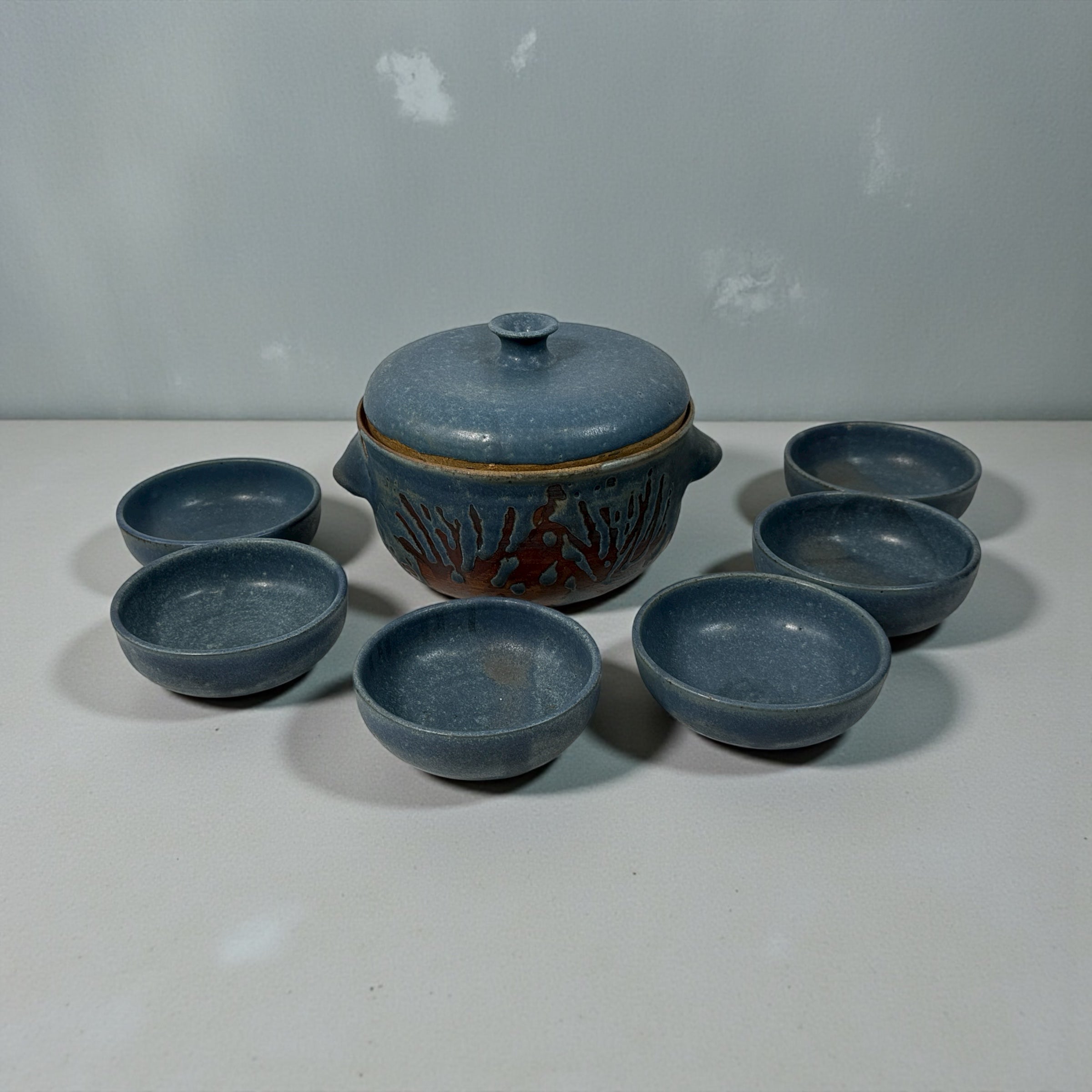 Handmade Québec studio pottery set signed Achard. Includes carved casserole with lid and six blue bowls. Vintage artisan ceramic tableware in excellent condition.
