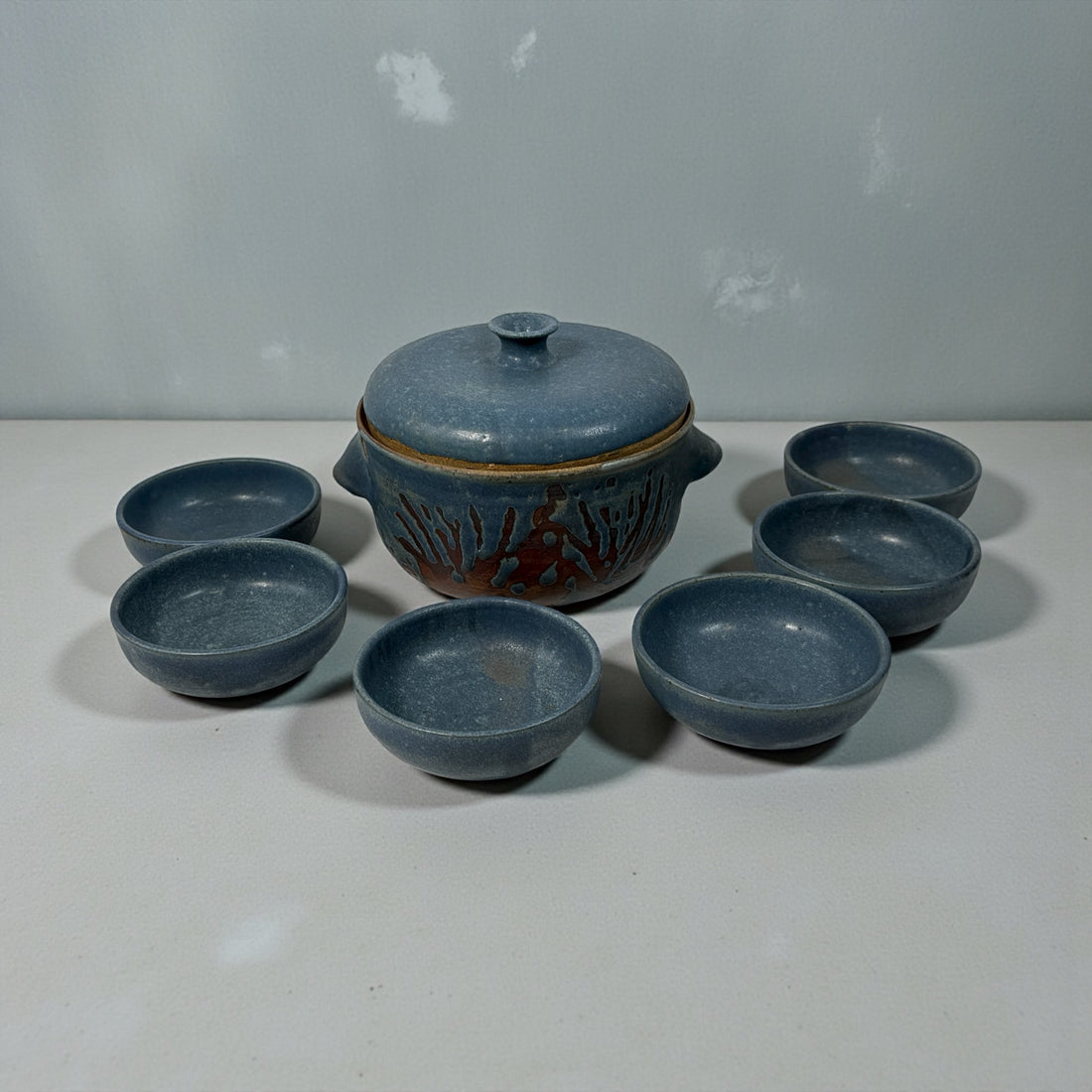 Handmade Québec studio pottery set signed Achard. Includes carved casserole with lid and six blue bowls. Vintage artisan ceramic tableware in excellent condition.