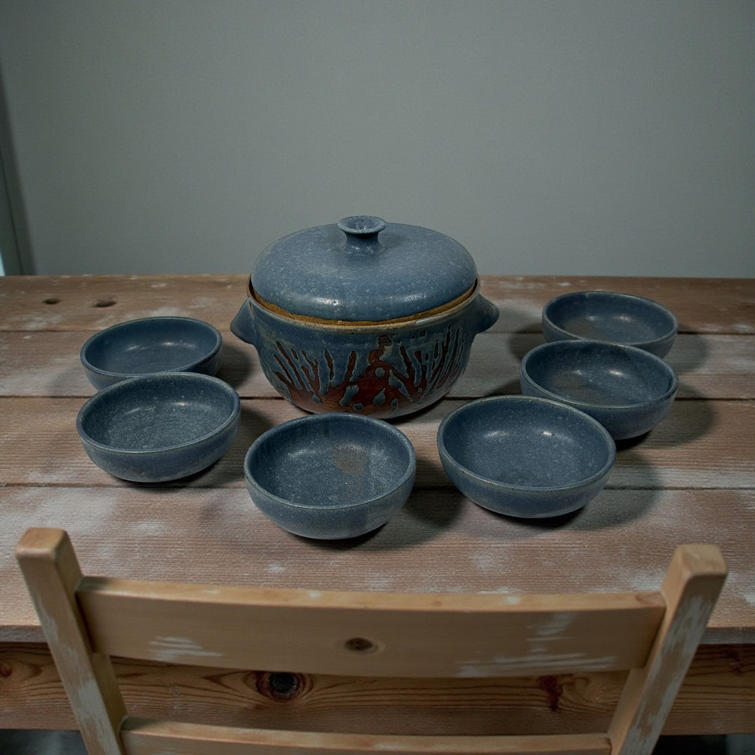 Handmade Québec studio pottery set signed Achard. Includes carved casserole with lid and six blue bowls. Vintage artisan ceramic tableware in excellent condition.