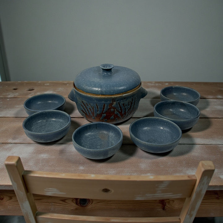 Handmade Québec studio pottery set signed Achard. Includes carved casserole with lid and six blue bowls. Vintage artisan ceramic tableware in excellent condition.