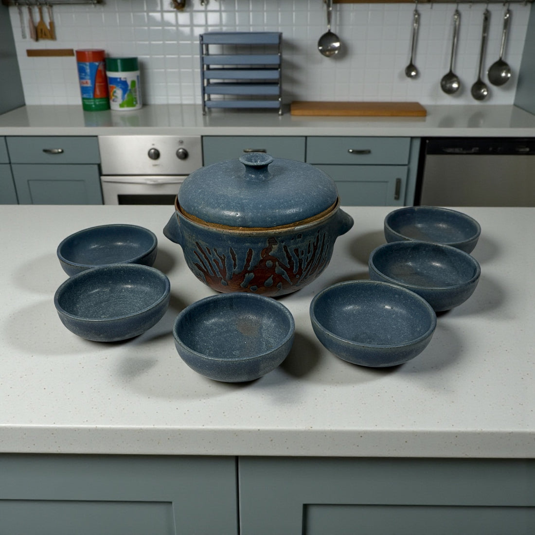 Handmade Québec studio pottery set signed Achard. Includes carved casserole with lid and six blue bowls. Vintage artisan ceramic tableware in excellent condition.