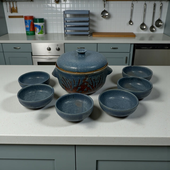 Handmade Québec studio pottery set signed Achard. Includes carved casserole with lid and six blue bowls. Vintage artisan ceramic tableware in excellent condition.