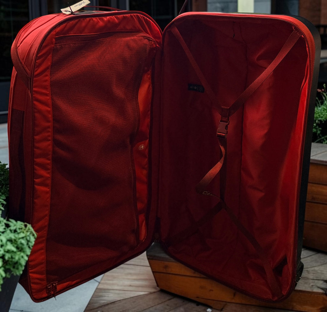 Official Lululemon Team Canada rolling suitcase in vibrant Olympic red. Large wheeled travel luggage with spacious interior, compression straps, and rare Canadian Olympic branding