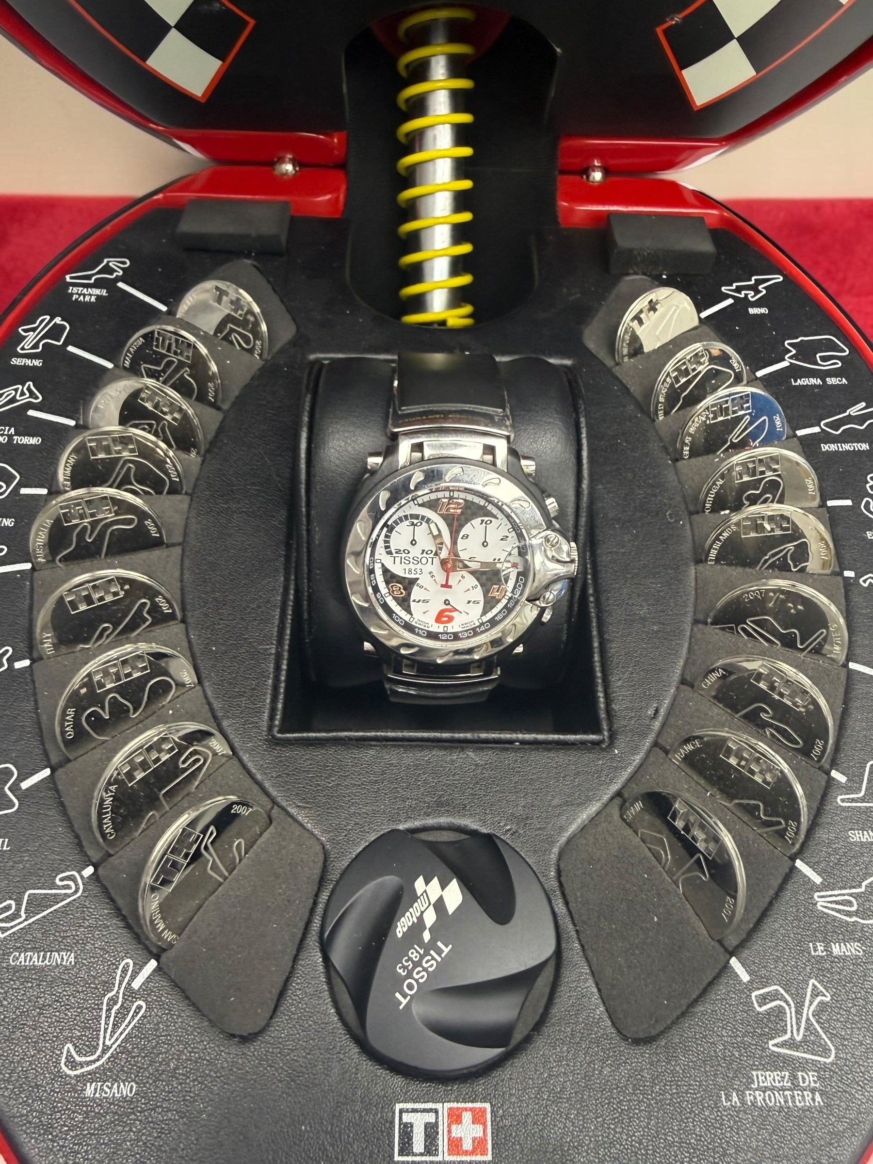 Rare Tissot T-Race MotoGP 2007 Limited Edition chronograph No. 1700/7002 with original helmet case, manuals, warranty card, and circuit medallions. Complete collector set.