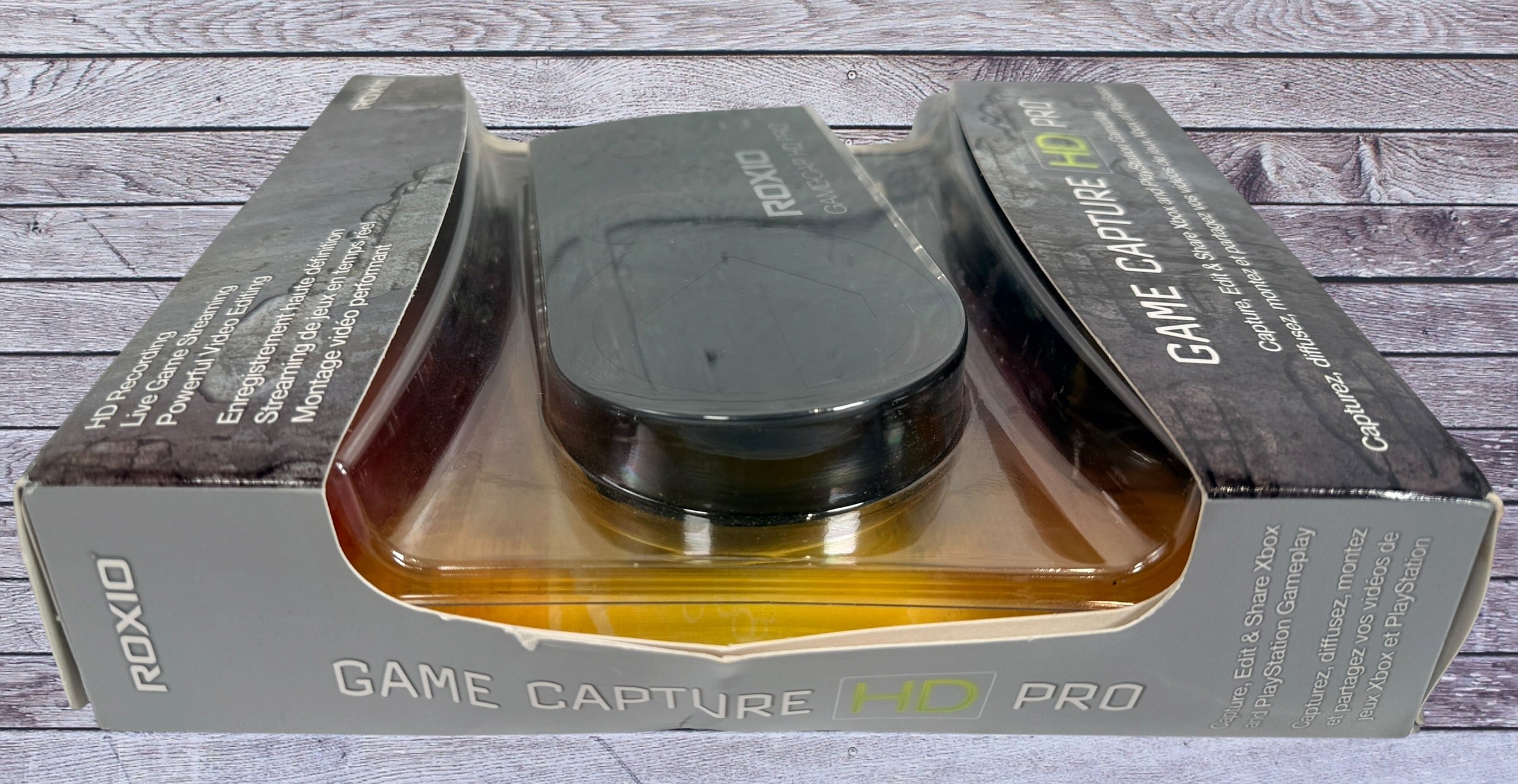 Capture Xbox and PlayStation gameplay with the Roxio Game Capture HD Pro. Includes original box, USB cable, HDMI support, and HD recording capability.
