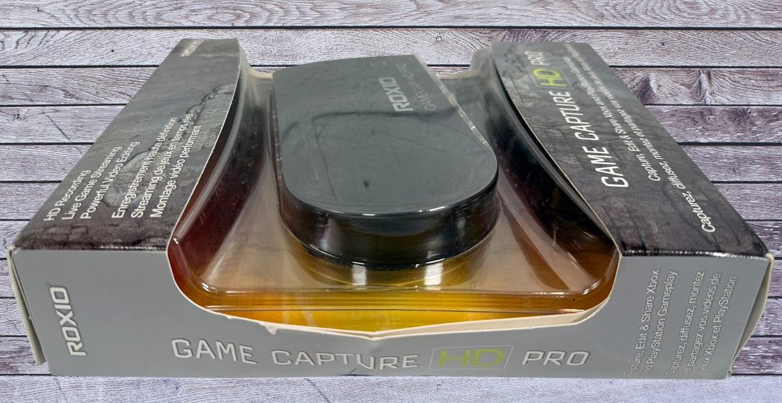 Capture Xbox and PlayStation gameplay with the Roxio Game Capture HD Pro. Includes original box, USB cable, HDMI support, and HD recording capability.