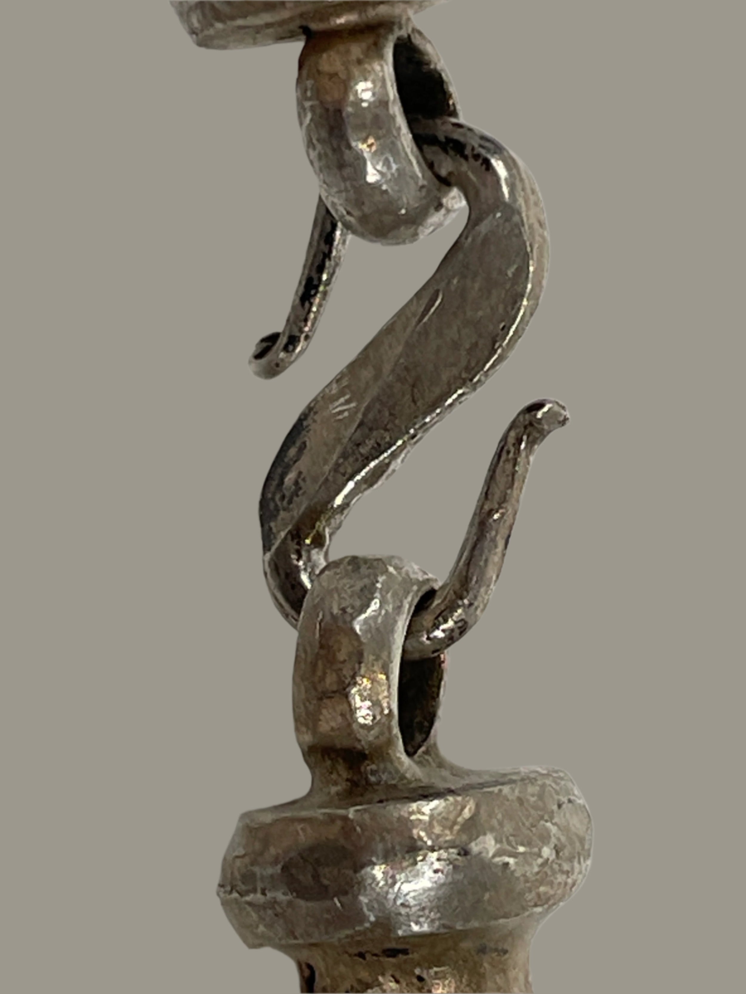 Close-up of a metal clasp on a white background