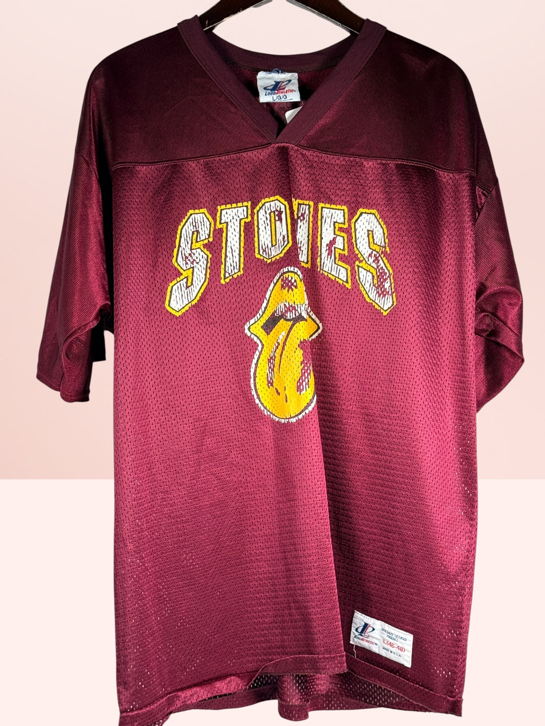 Authentic vintage Rolling Stones 98 football jersey by LogoAthletic. Official licensed USA-made burgundy mesh shirt with classic tongue logo and oversized 90s fit.