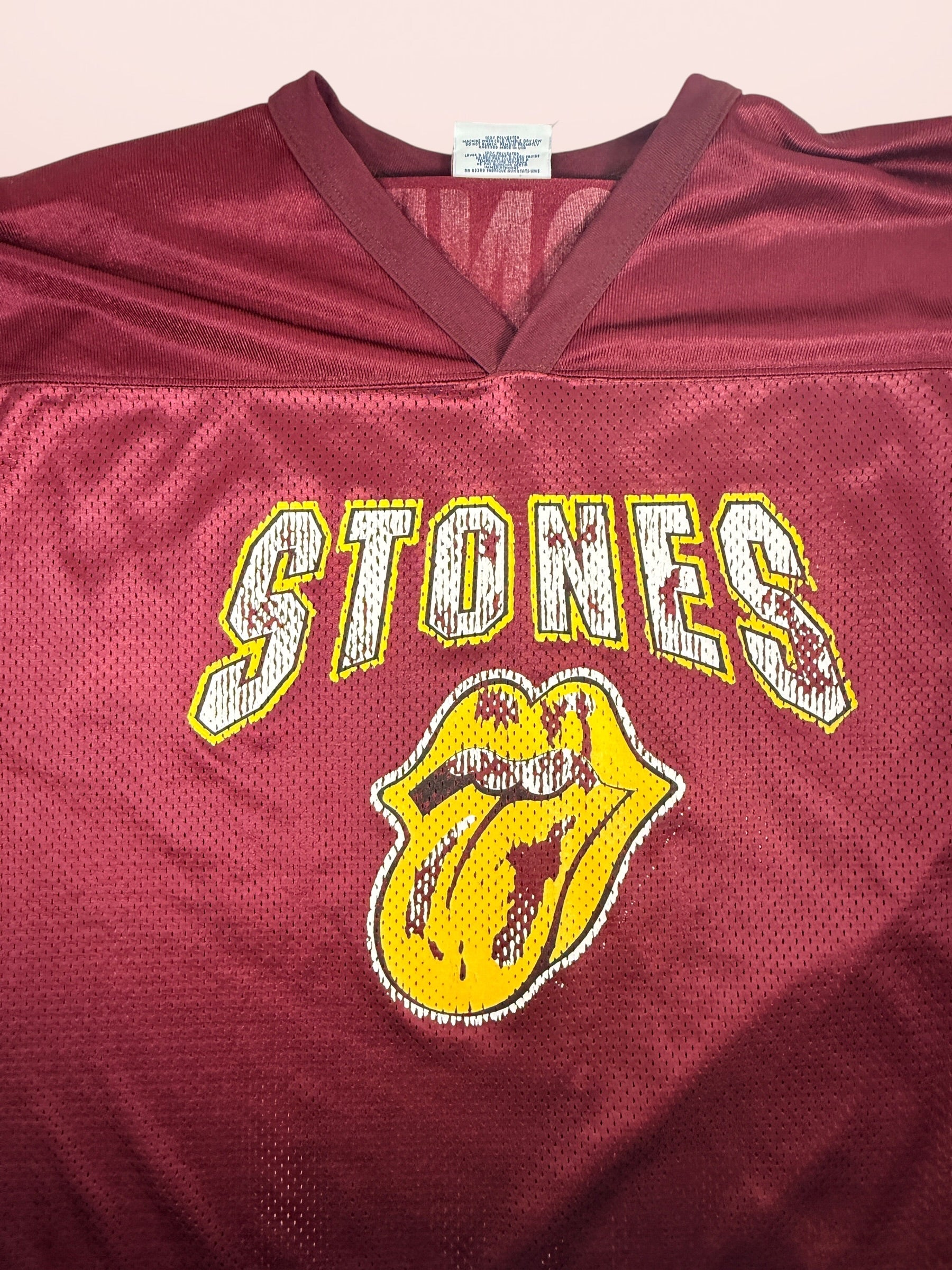 Authentic vintage Rolling Stones 98 football jersey by LogoAthletic. Official licensed USA-made burgundy mesh shirt with classic tongue logo and oversized 90s fit.