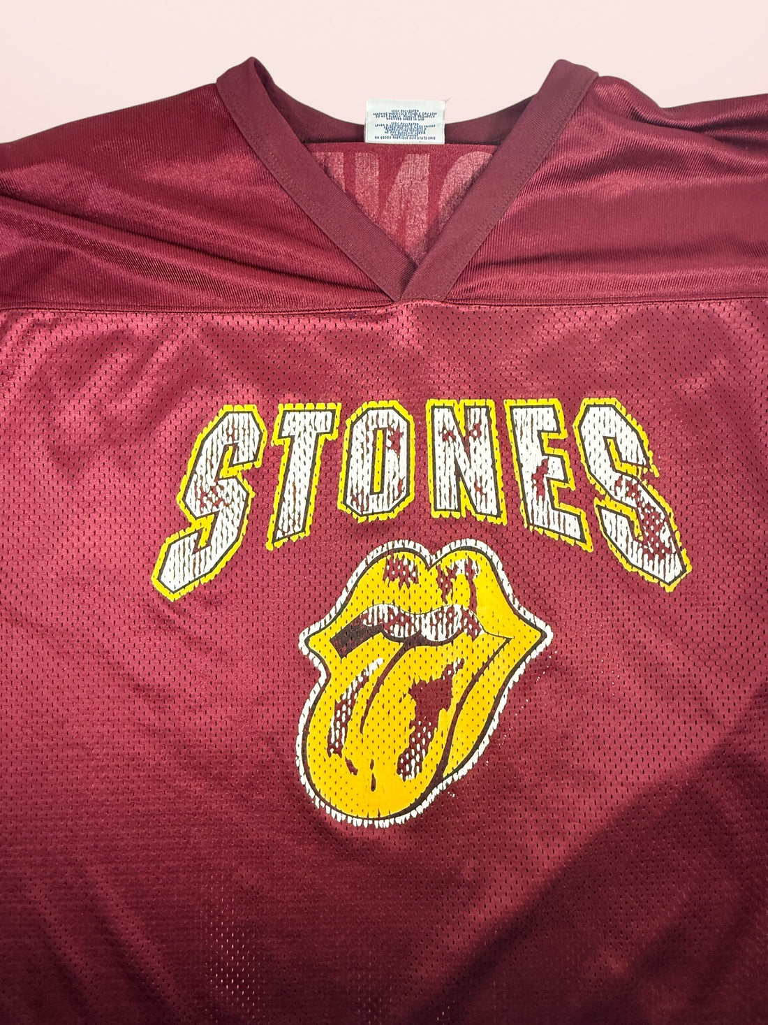 Authentic vintage Rolling Stones 98 football jersey by LogoAthletic. Official licensed USA-made burgundy mesh shirt with classic tongue logo and oversized 90s fit.