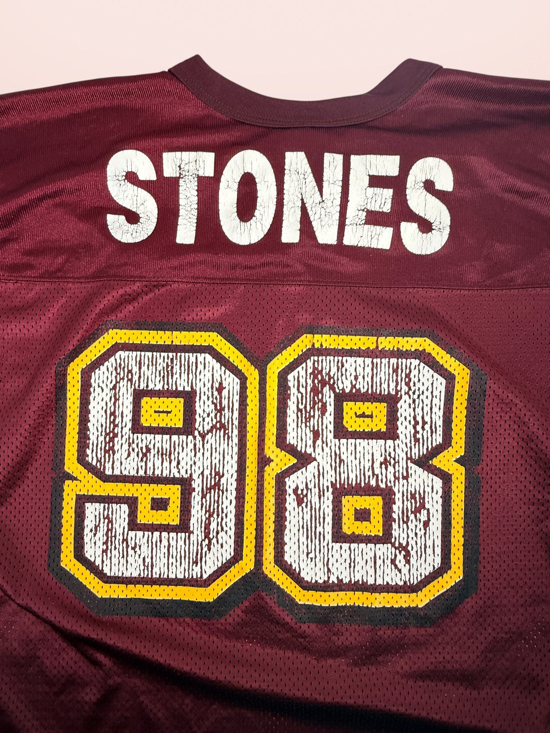 Authentic vintage Rolling Stones 98 football jersey by LogoAthletic. Official licensed USA-made burgundy mesh shirt with classic tongue logo and oversized 90s fit.
