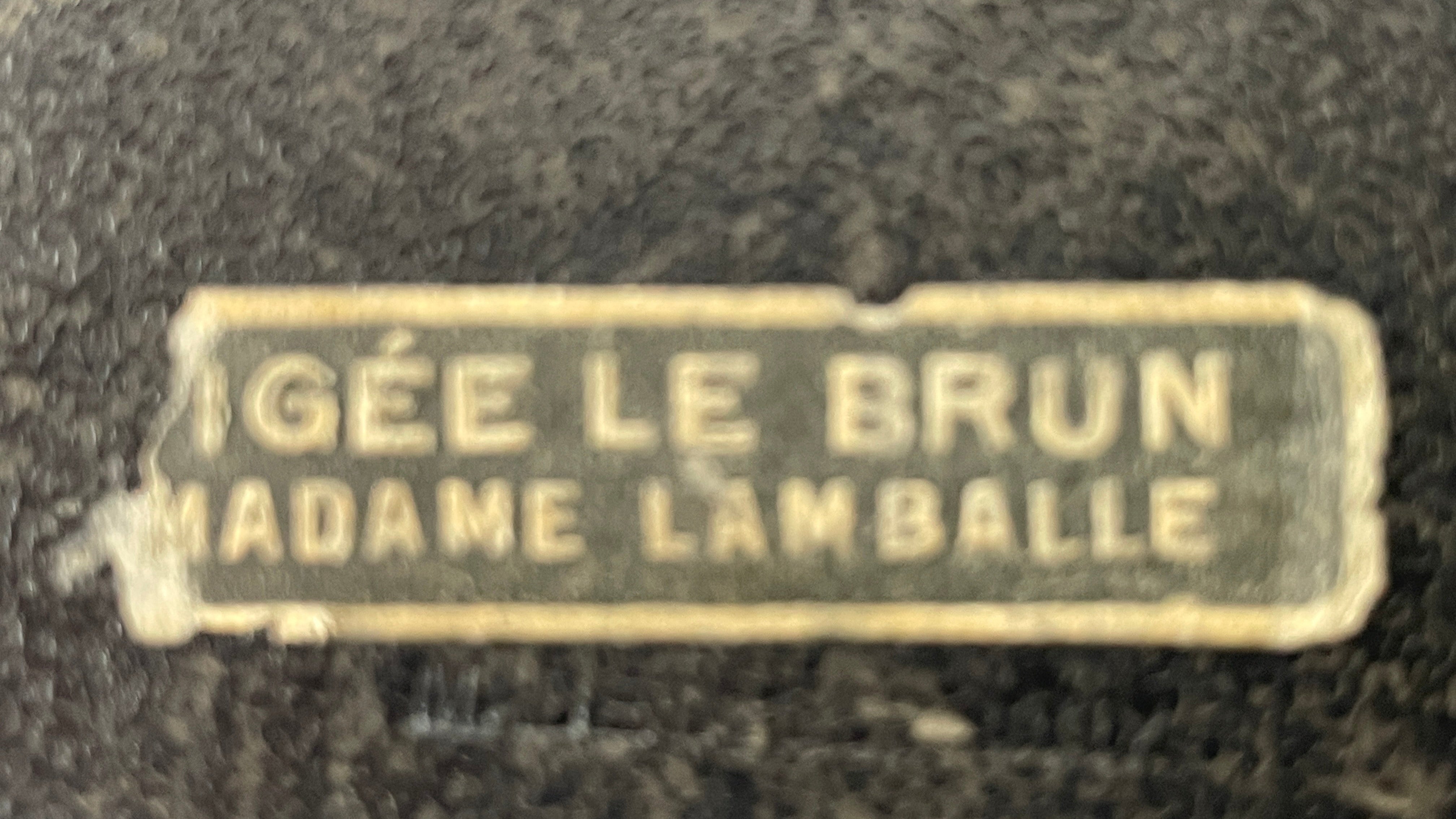 Metallic nameplate with engraved text on a dark background
