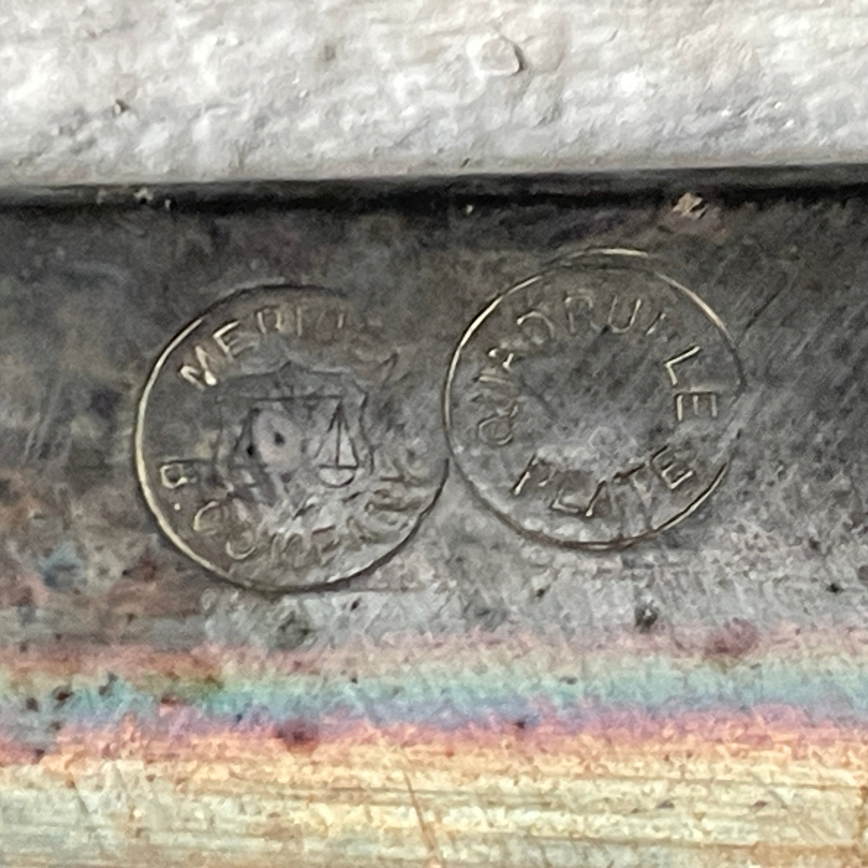 Metal surface with engraved text and a rainbow effect