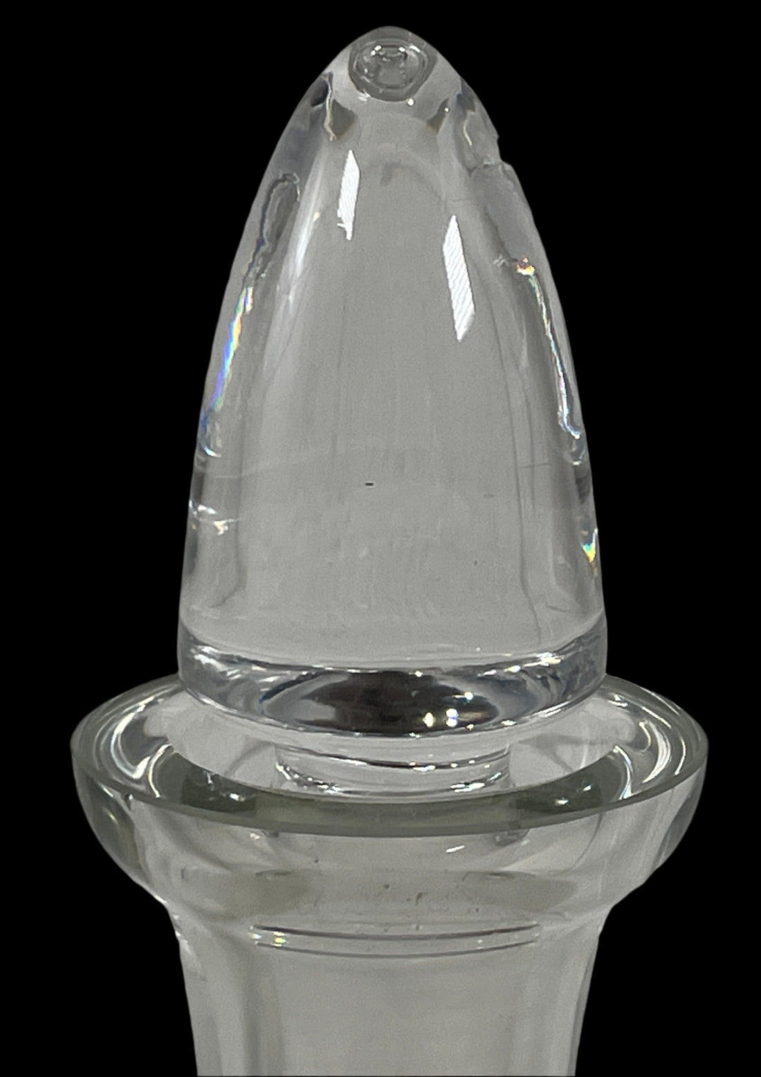 Clear glass oil dispenser on a white brick wall background