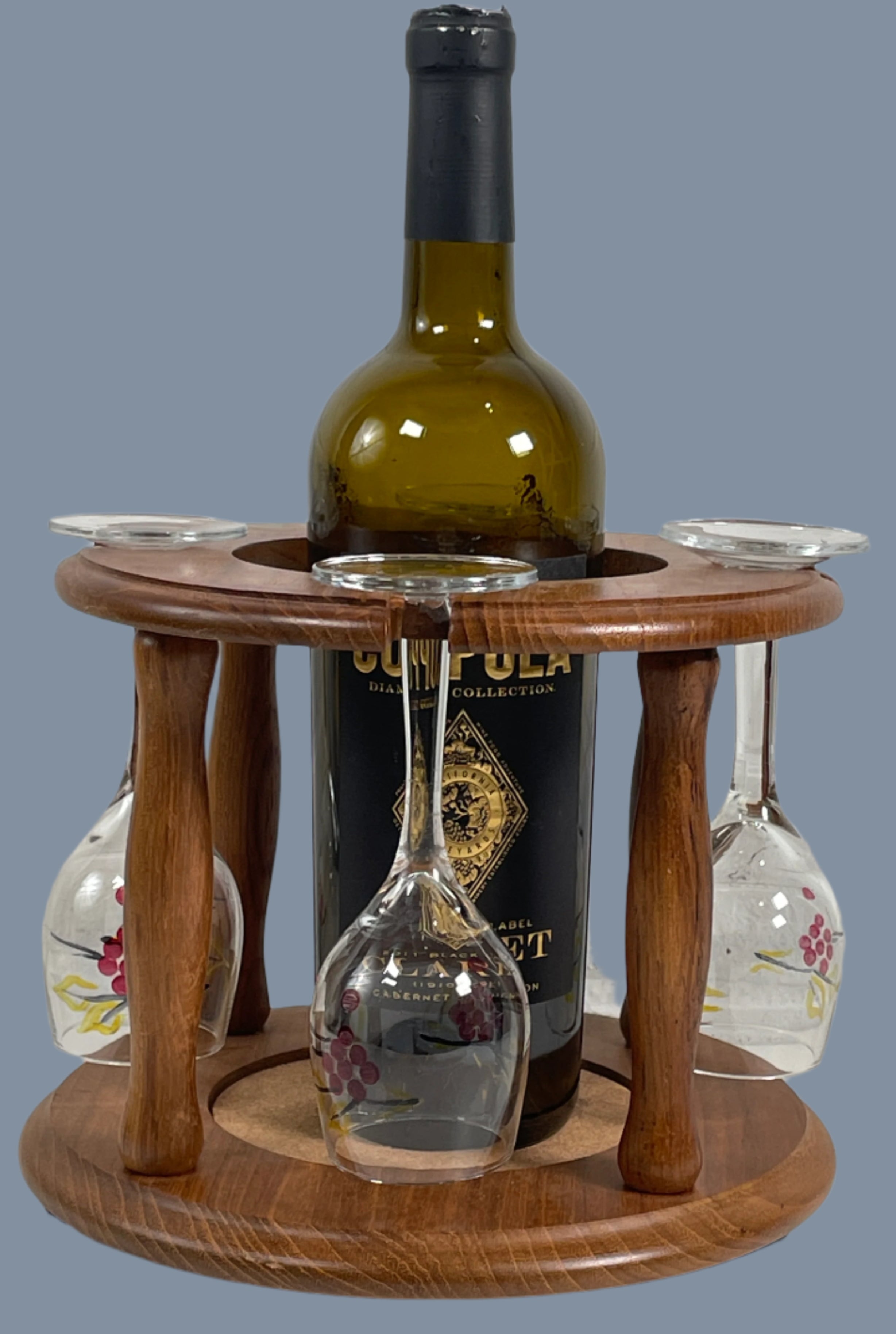 Wooden wine bottle and glass holder with bottles on a textured white surface