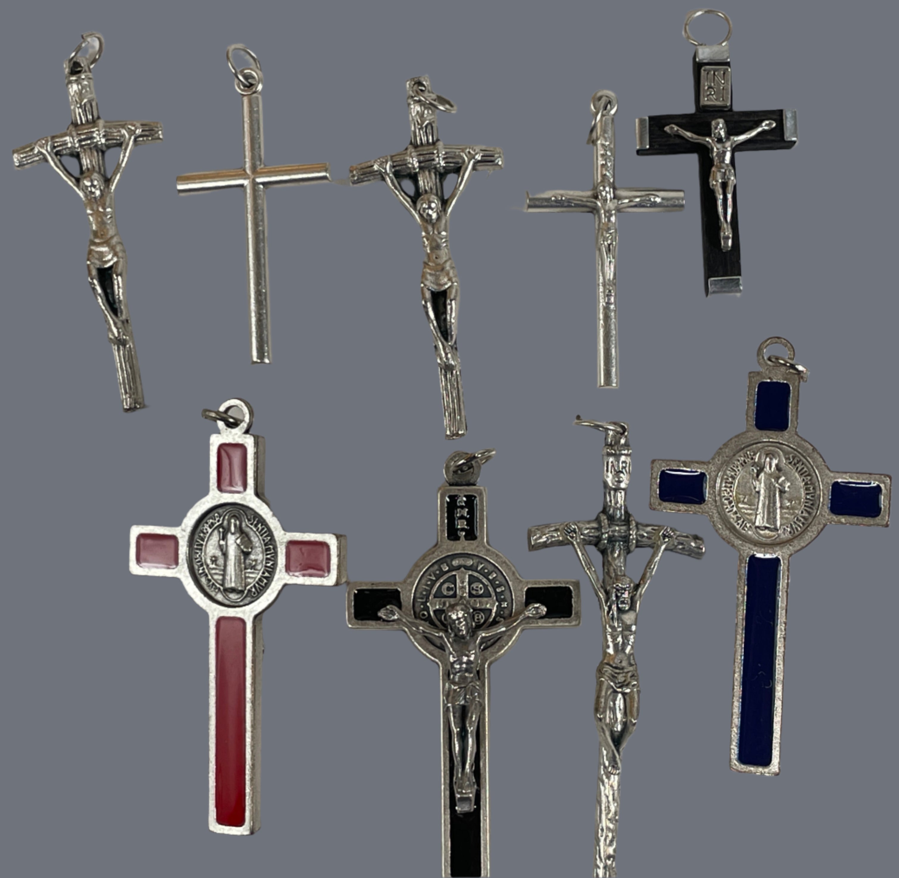 Collection of silver and metal crucifixes on a white background