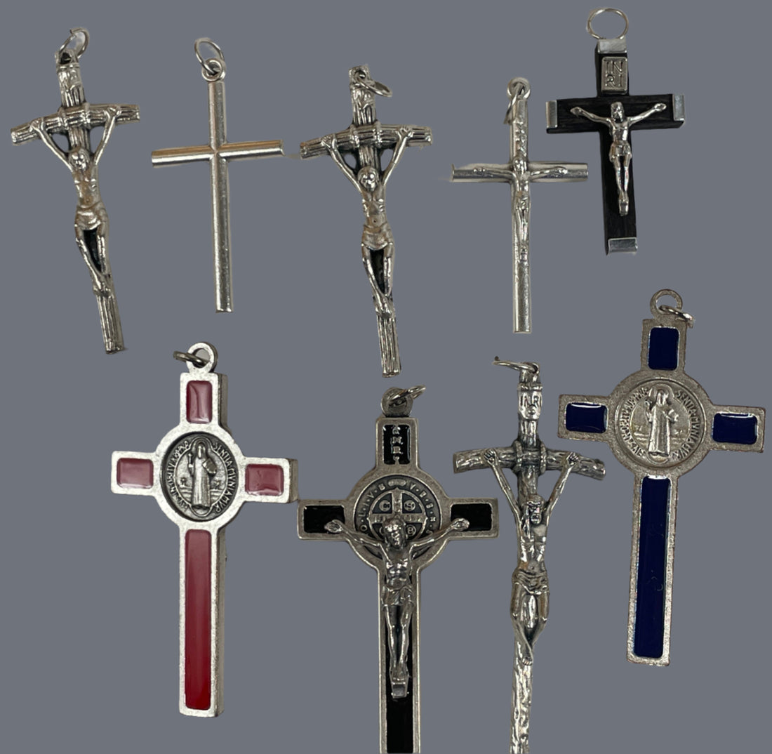Collection of silver and metal crucifixes on a white background