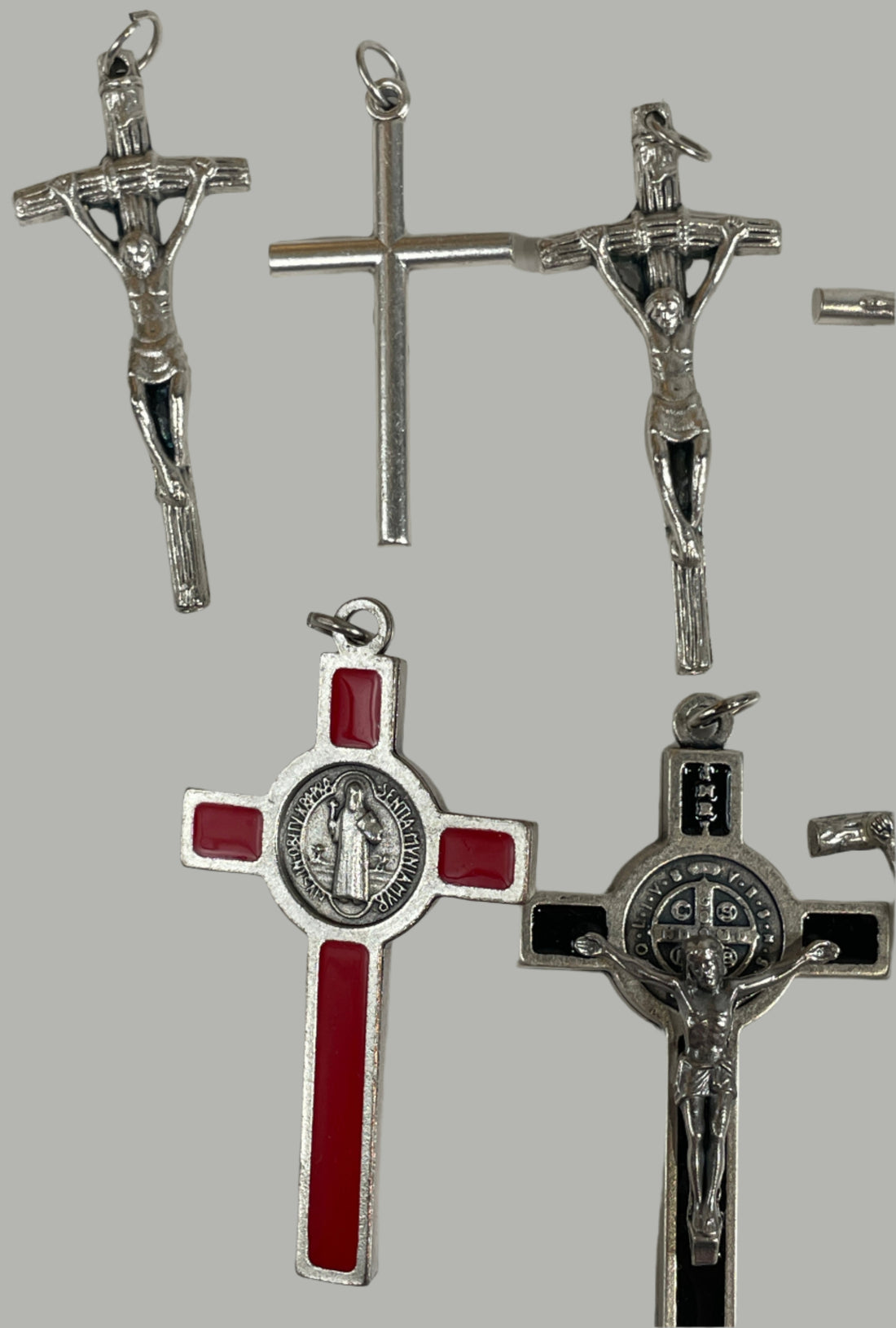 Collection of silver and red crosses on a white surface