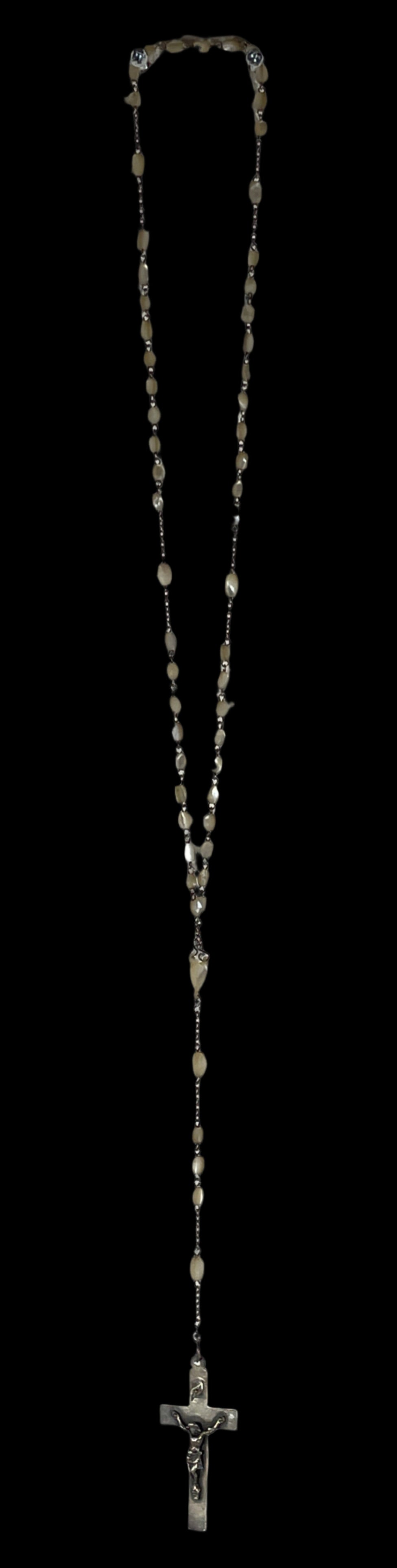 Metal chain on a textured white wall