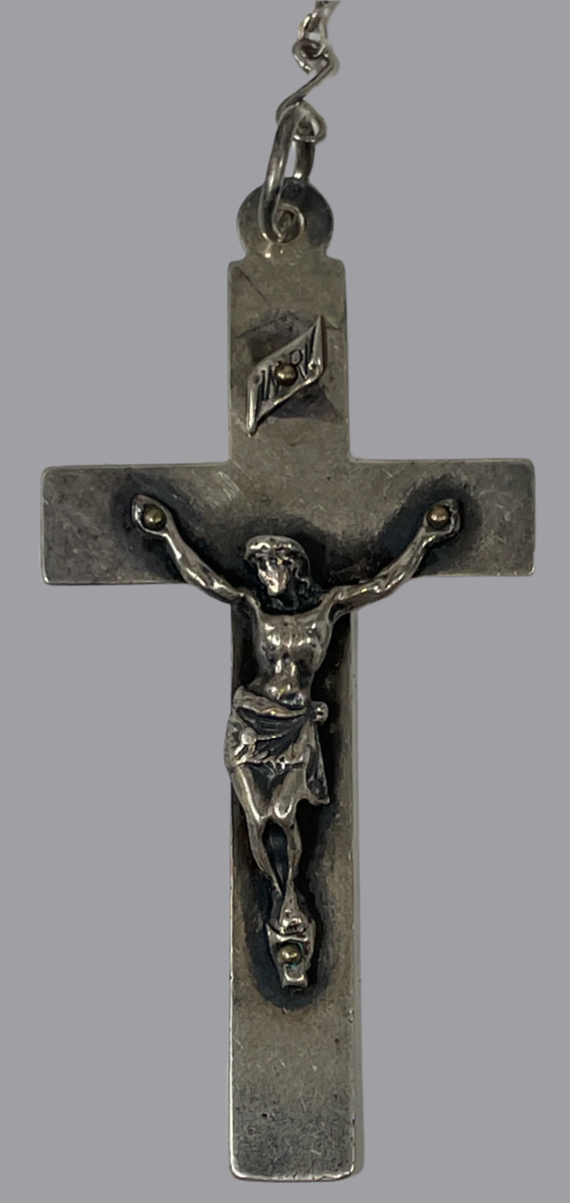 Silver crucifix on a white background