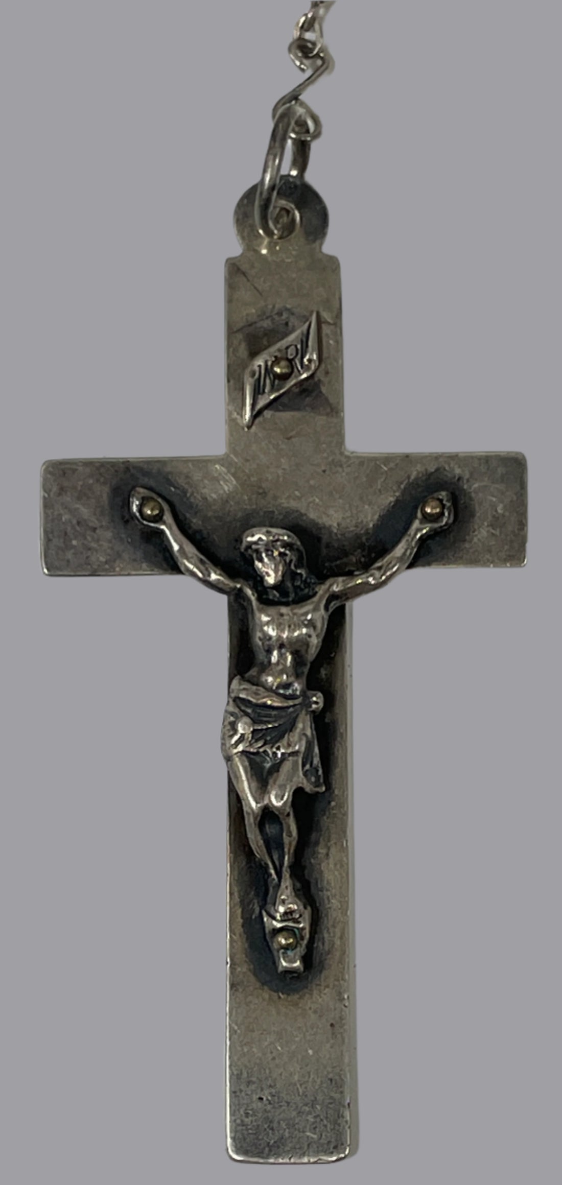 Silver crucifix on a white background