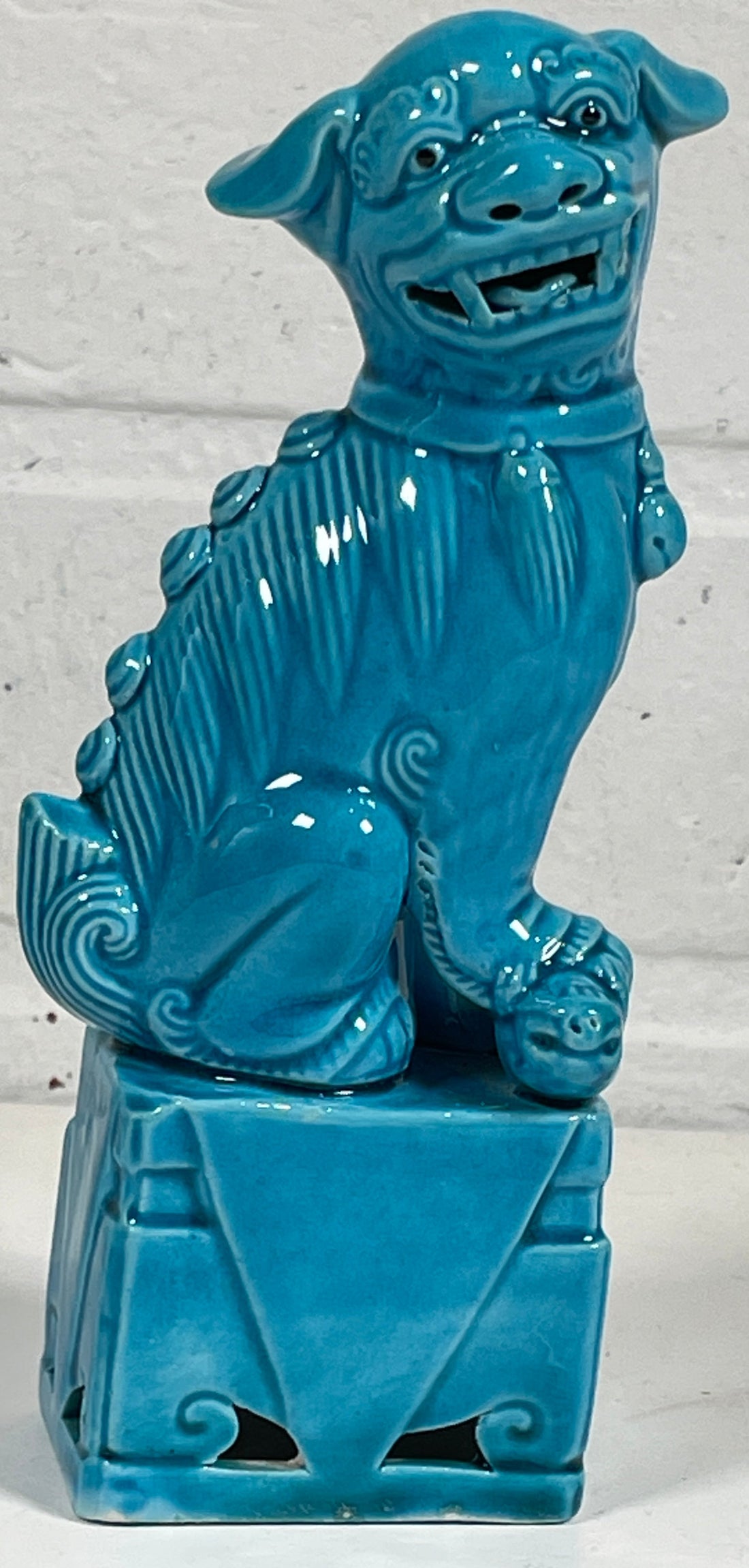 Blue ceramic dog -shaped object on a white background